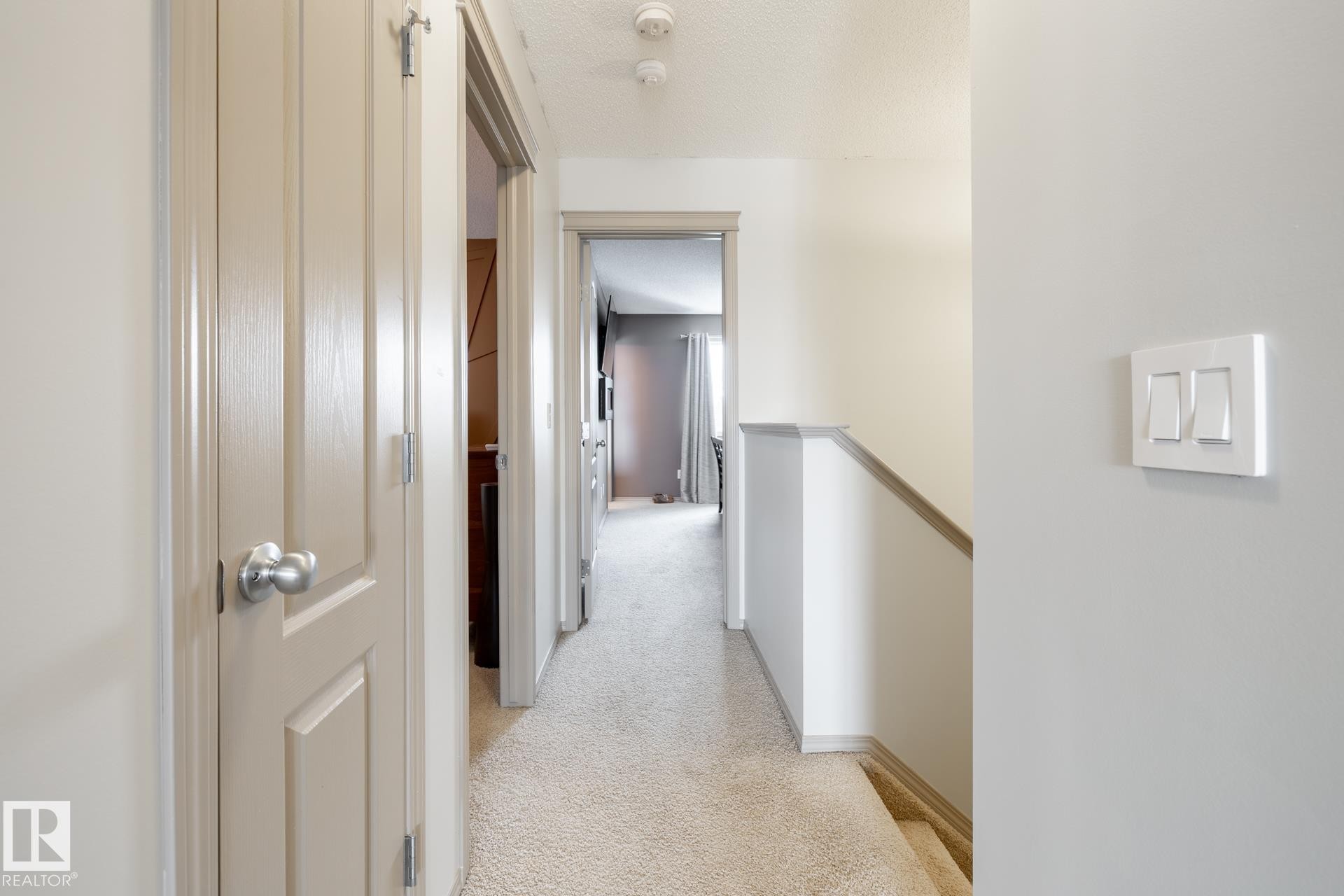 Corridor featuring an upstairs landing and light colored carpet - 3312 17B Avenue, Edmonton, AB - Indoor Photo Showing Other Room