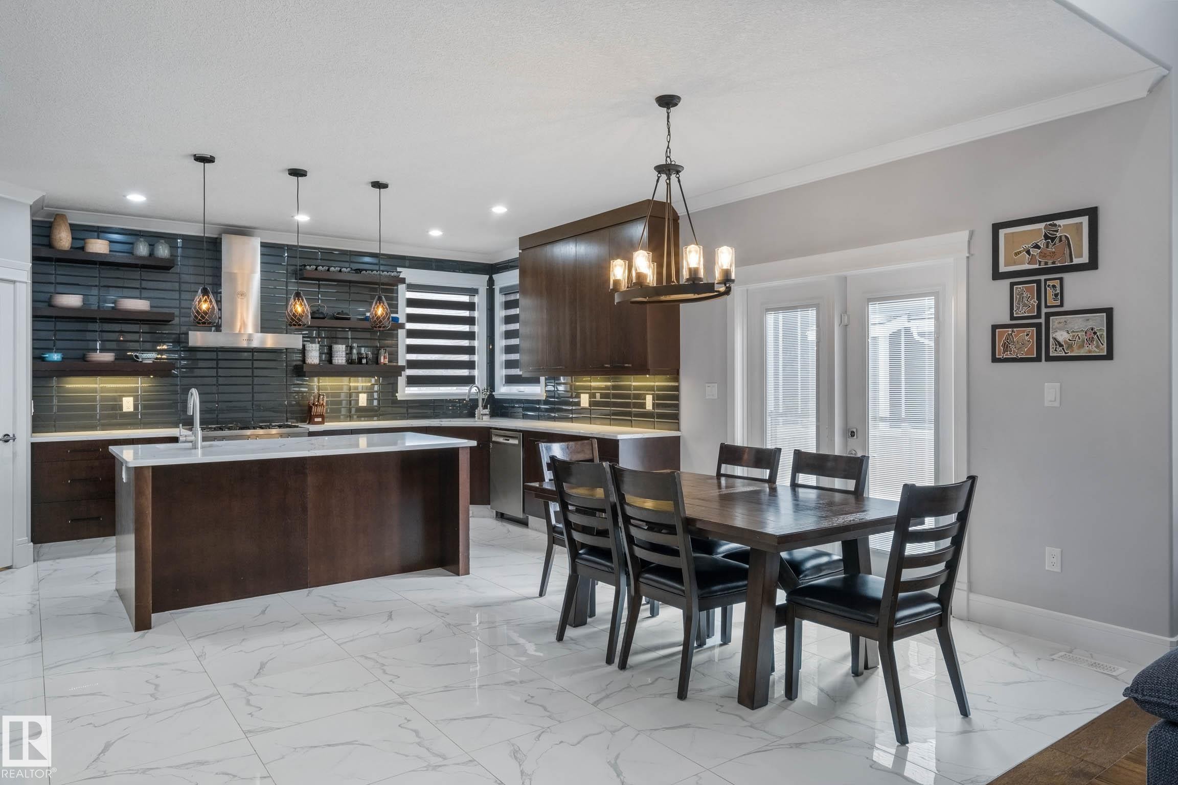 Dining area with ornamental molding, a chandelier, and light marble finish floors - 4086 Whispering River Drive, Edmonton, AB - Indoor