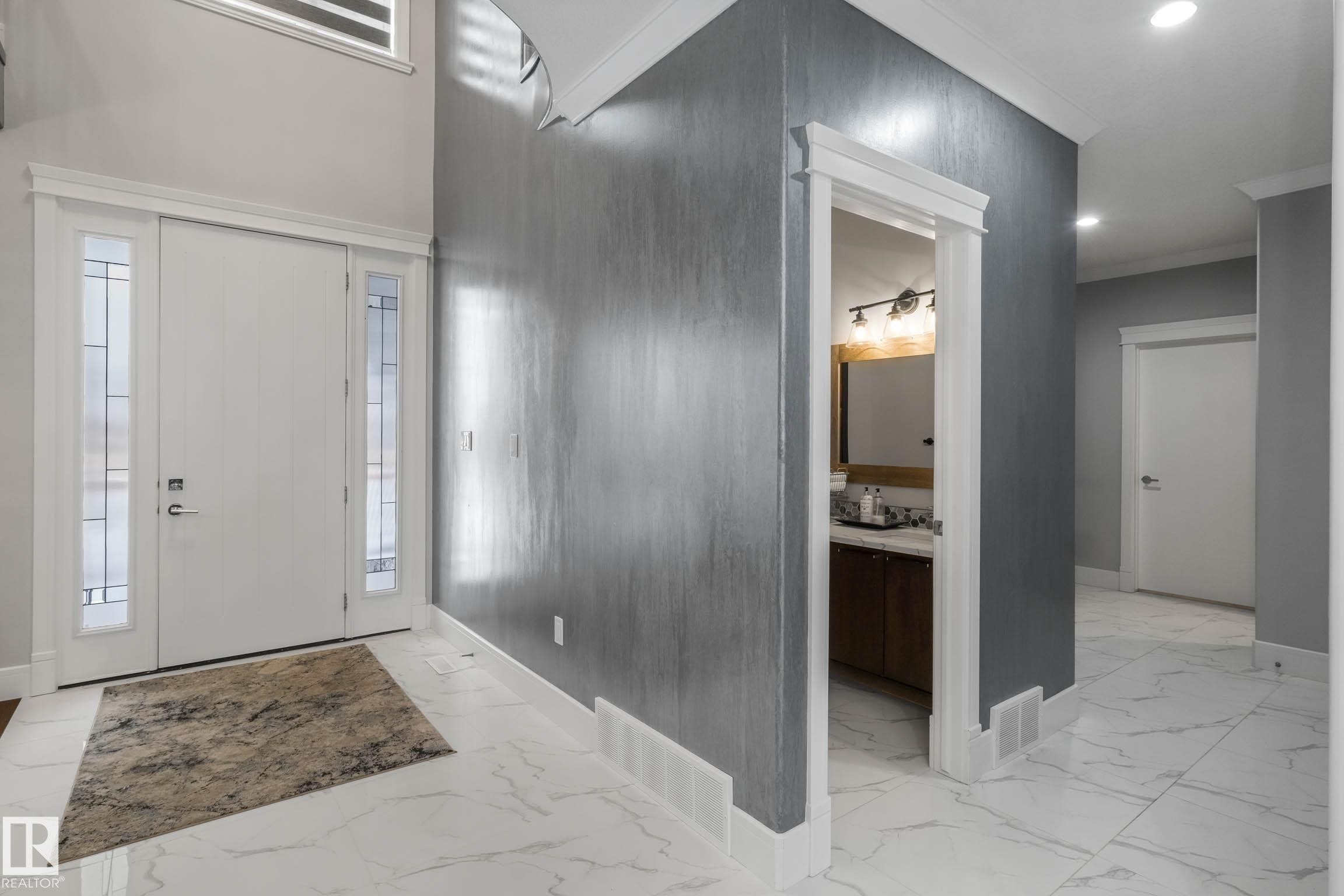 Foyer featuring light marble finish flooring, recessed lighting, and crown molding - 4086 Whispering River Drive, Edmonton, AB - Indoor Photo Showing Other Room