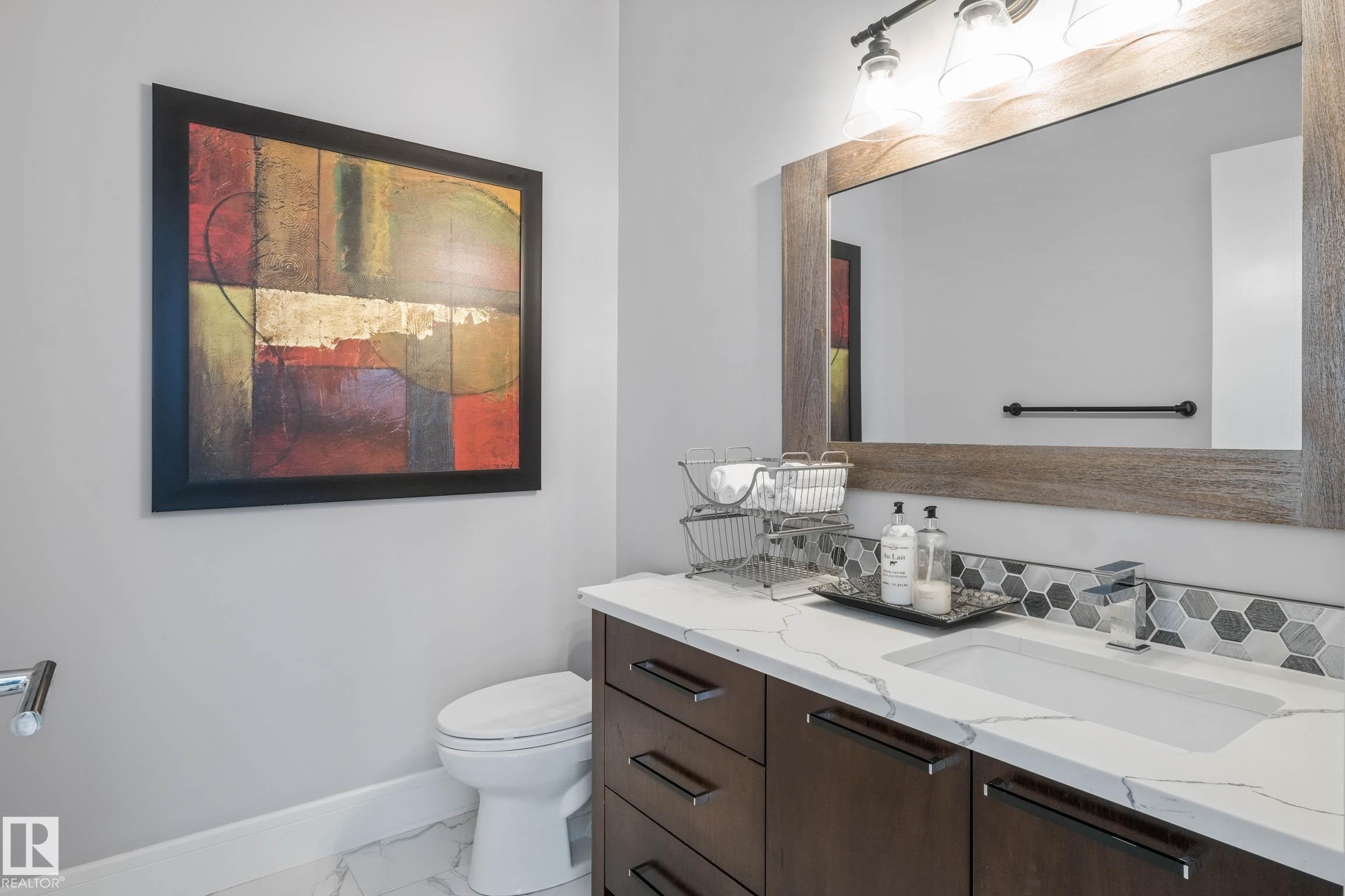 Half bath with vanity and light marble finish flooring - 4086 Whispering River Drive, Edmonton, AB - Indoor Photo Showing Bathroom