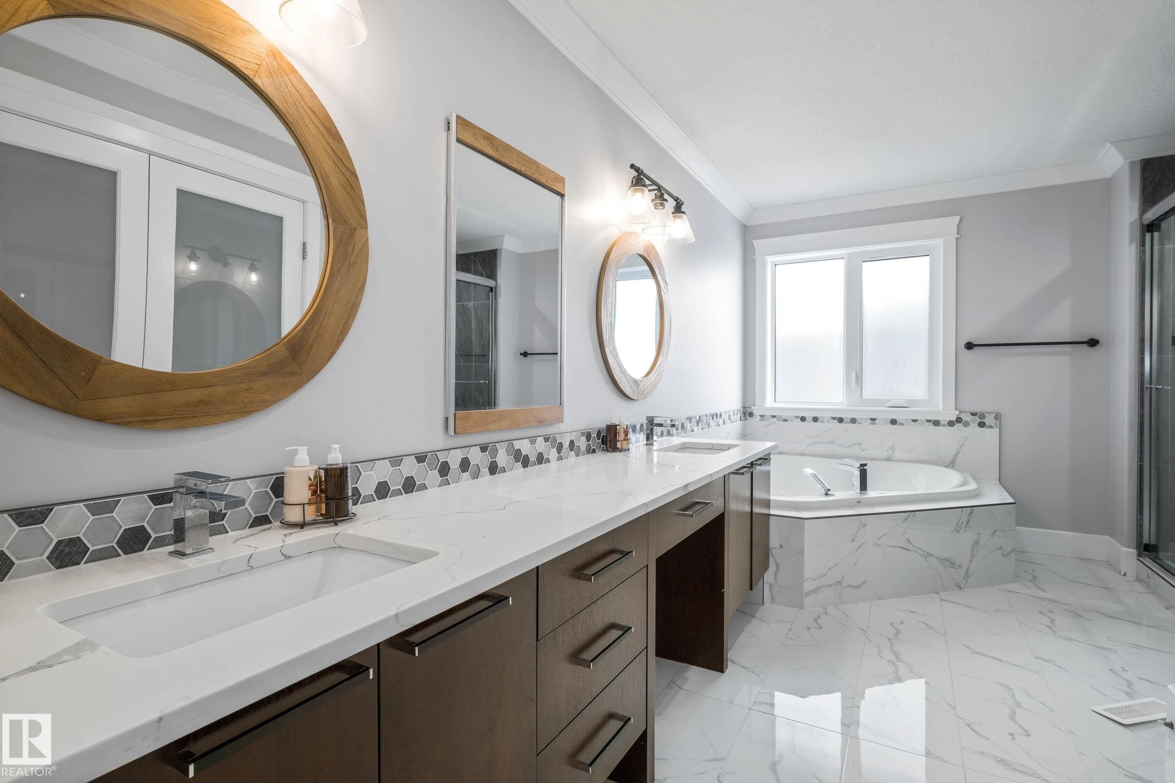 Bathroom featuring double vanity, a garden tub, a stall shower, ornamental molding, and light marble finish floors - 4086 Whispering River Drive, Edmonton, AB - Indoor Photo Showing Bathroom