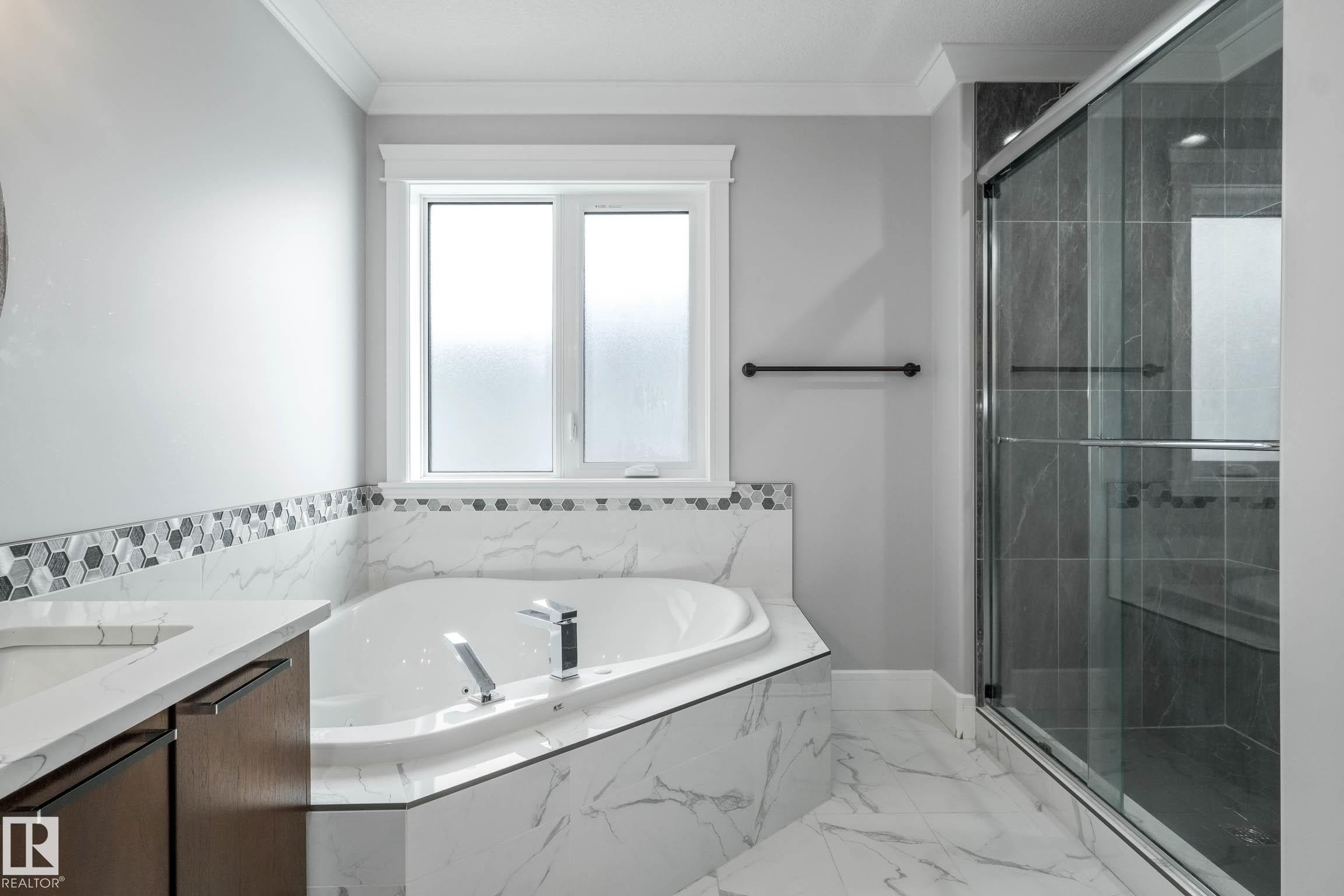 Full bathroom featuring vanity, a marble finish shower, ornamental molding, a garden tub, and light marble finish flooring - 4086 Whispering River Drive, Edmonton, AB - Indoor Photo Showing Bathroom