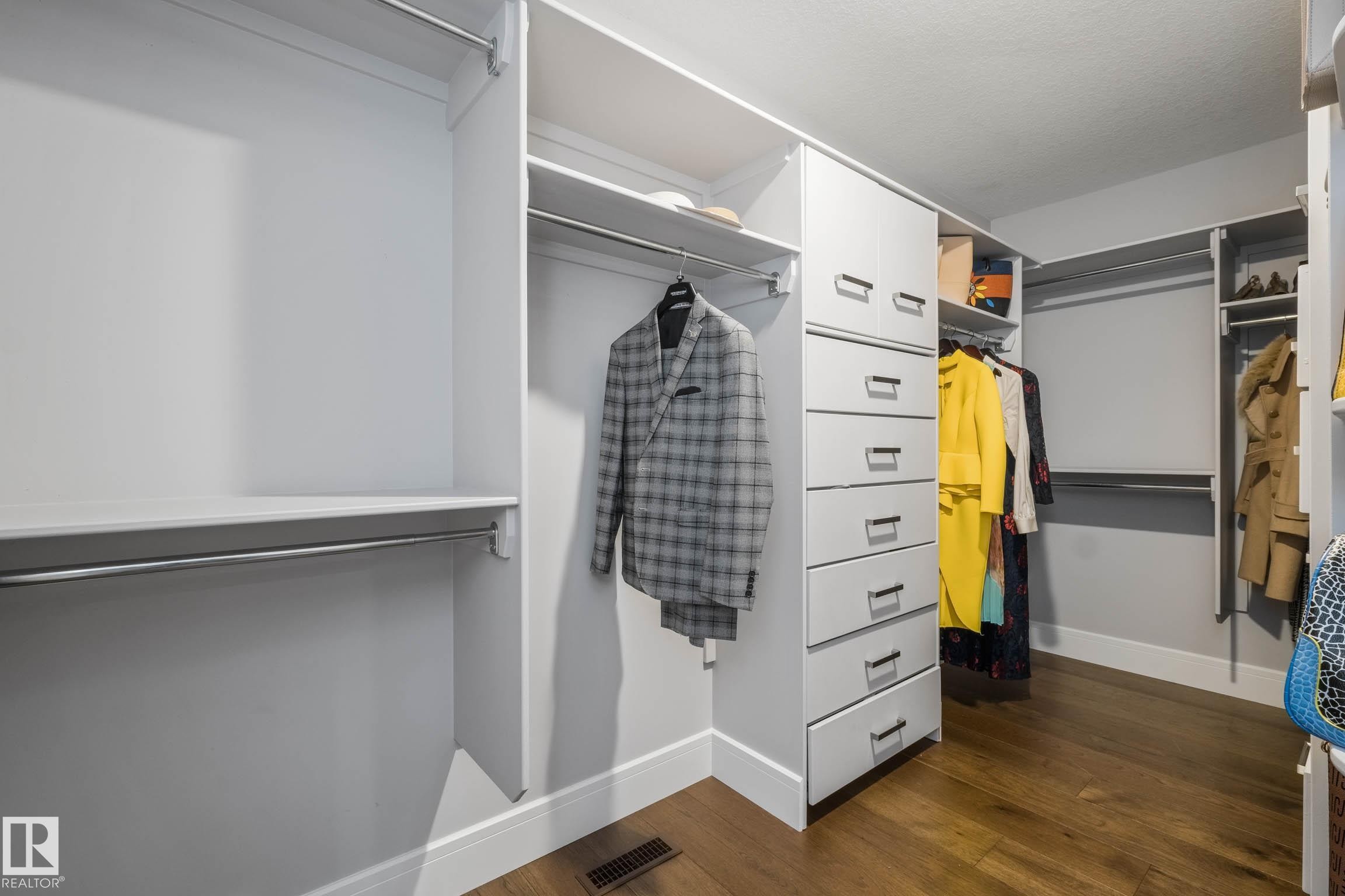 Walk in closet featuring dark wood finished floors - 4086 Whispering River Drive, Edmonton, AB - Indoor