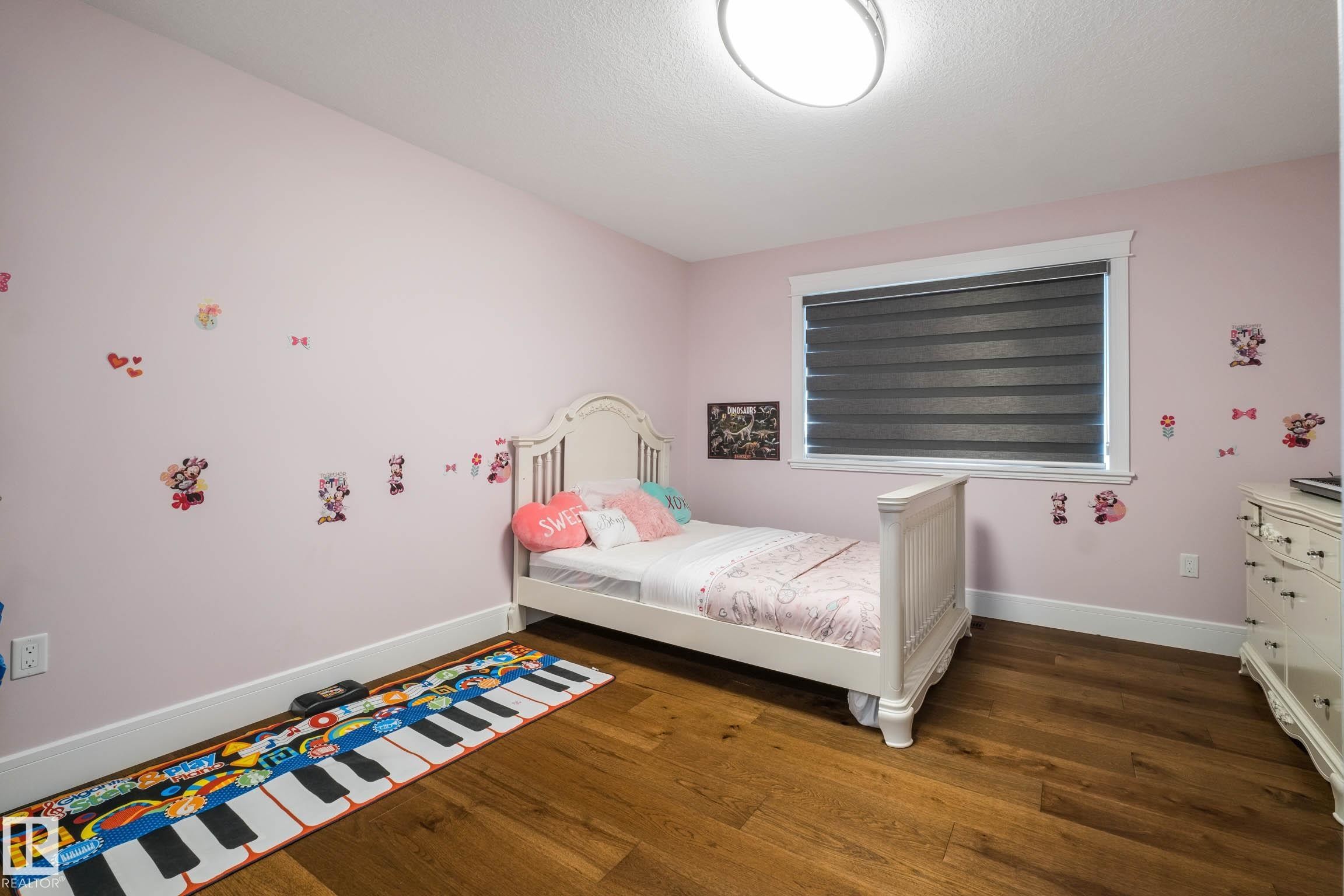 Bedroom with baseboards and dark wood-type flooring - 4086 Whispering River Drive, Edmonton, AB - Indoor Photo Showing Bedroom