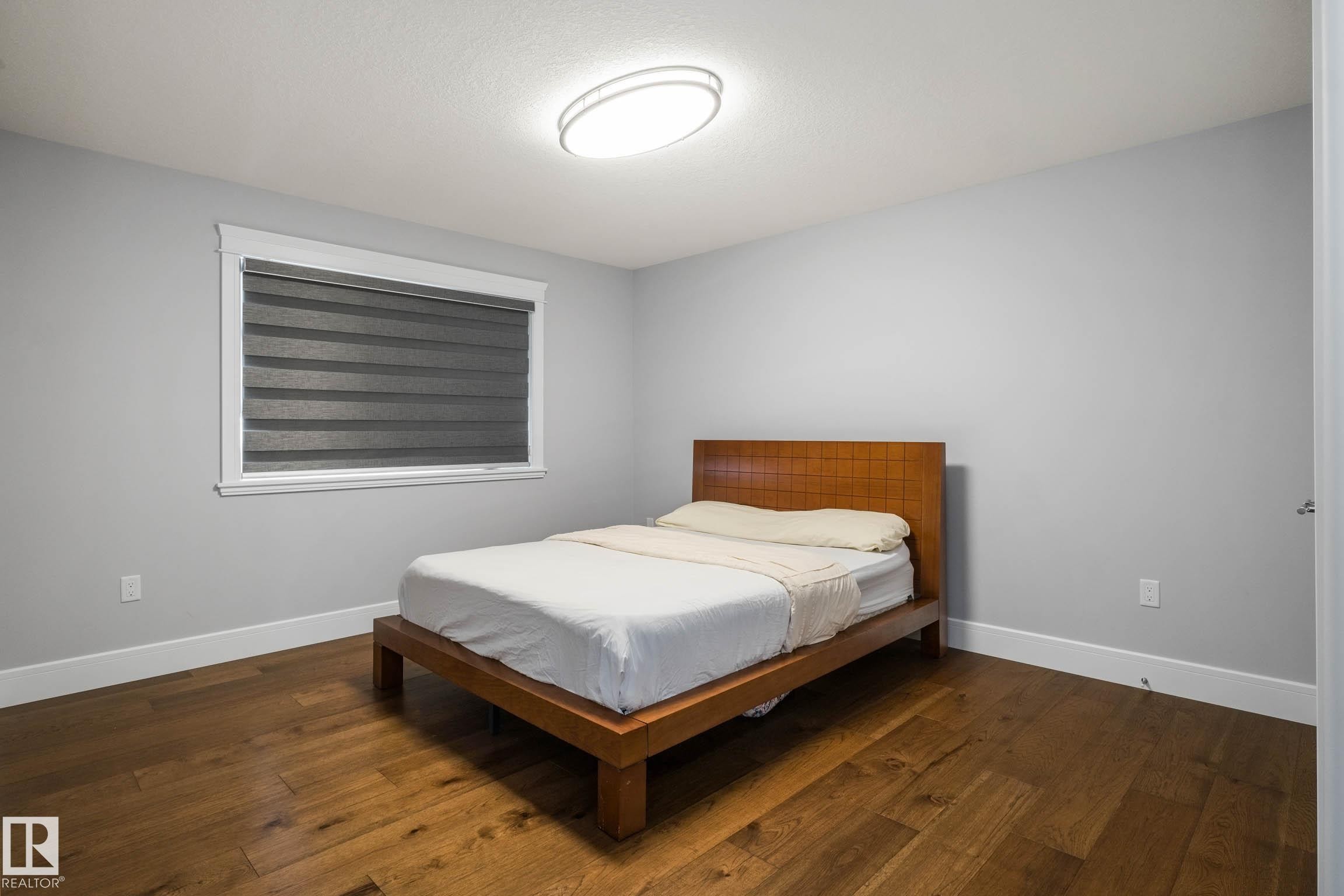 Bedroom with dark wood-style flooring - 4086 Whispering River Drive, Edmonton, AB - Indoor Photo Showing Bedroom