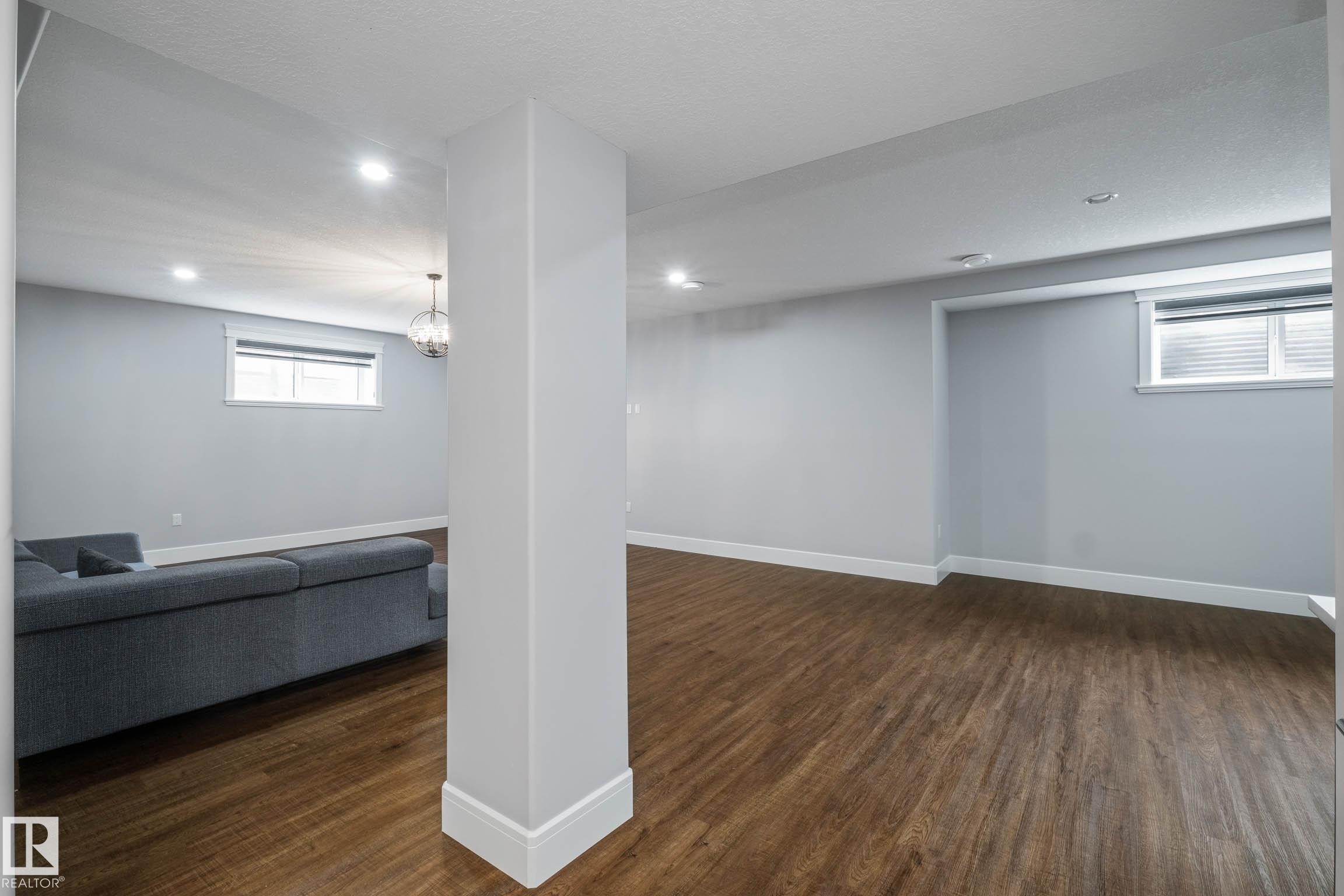 Basement featuring dark wood-type flooring and recessed lighting - 4086 Whispering River Drive, Edmonton, AB - Indoor