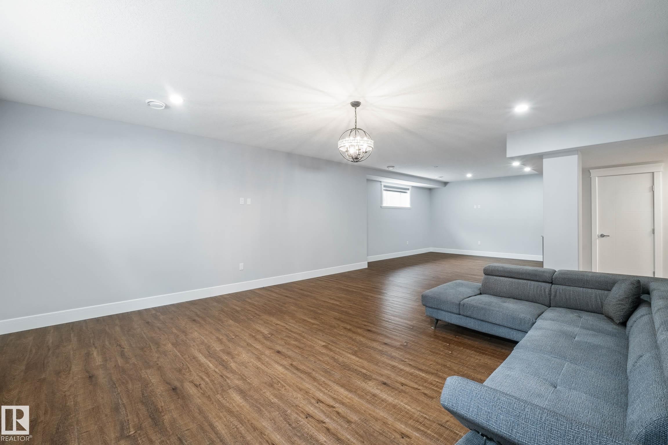 Living area featuring dark wood finished floors and recessed lighting - 4086 Whispering River Drive, Edmonton, AB - Indoor
