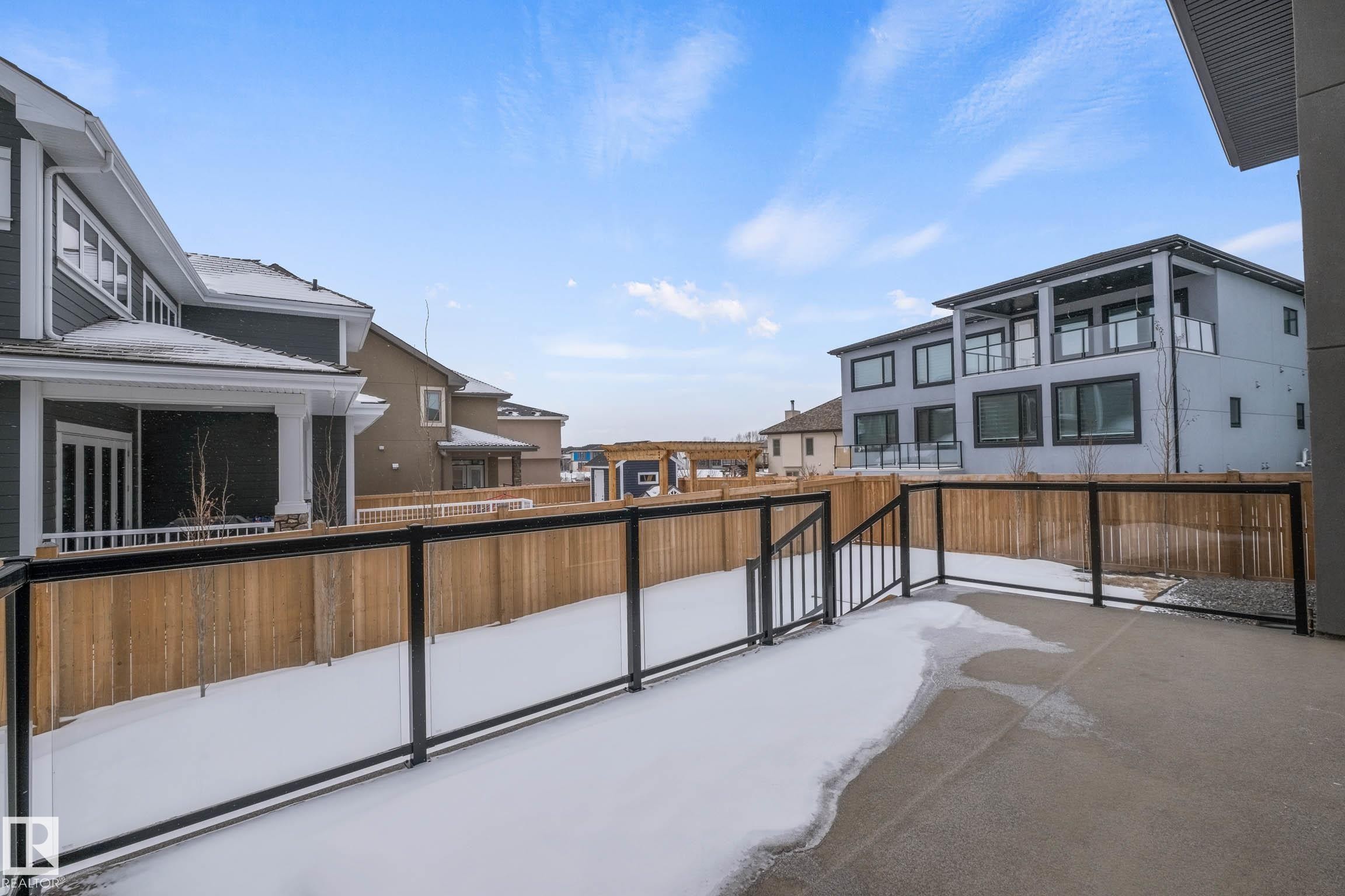 Fenced backyard featuring a residential view and a patio - 4086 Whispering River Drive, Edmonton, AB - Outdoor With Exterior