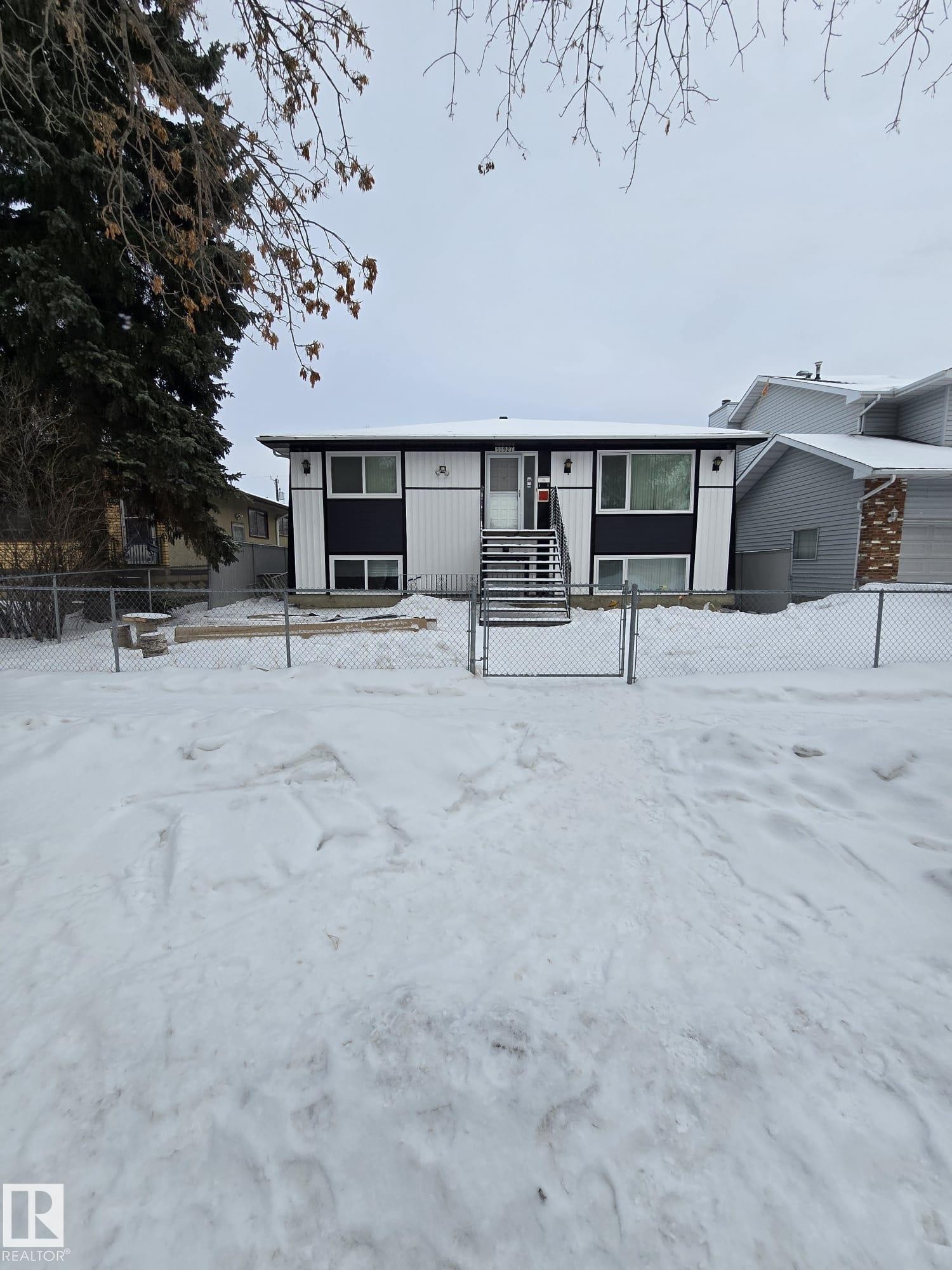 View of front of property with a fenced front yard and a gate - 11927 85 Street Nw, Edmonton, AB - Outdoor