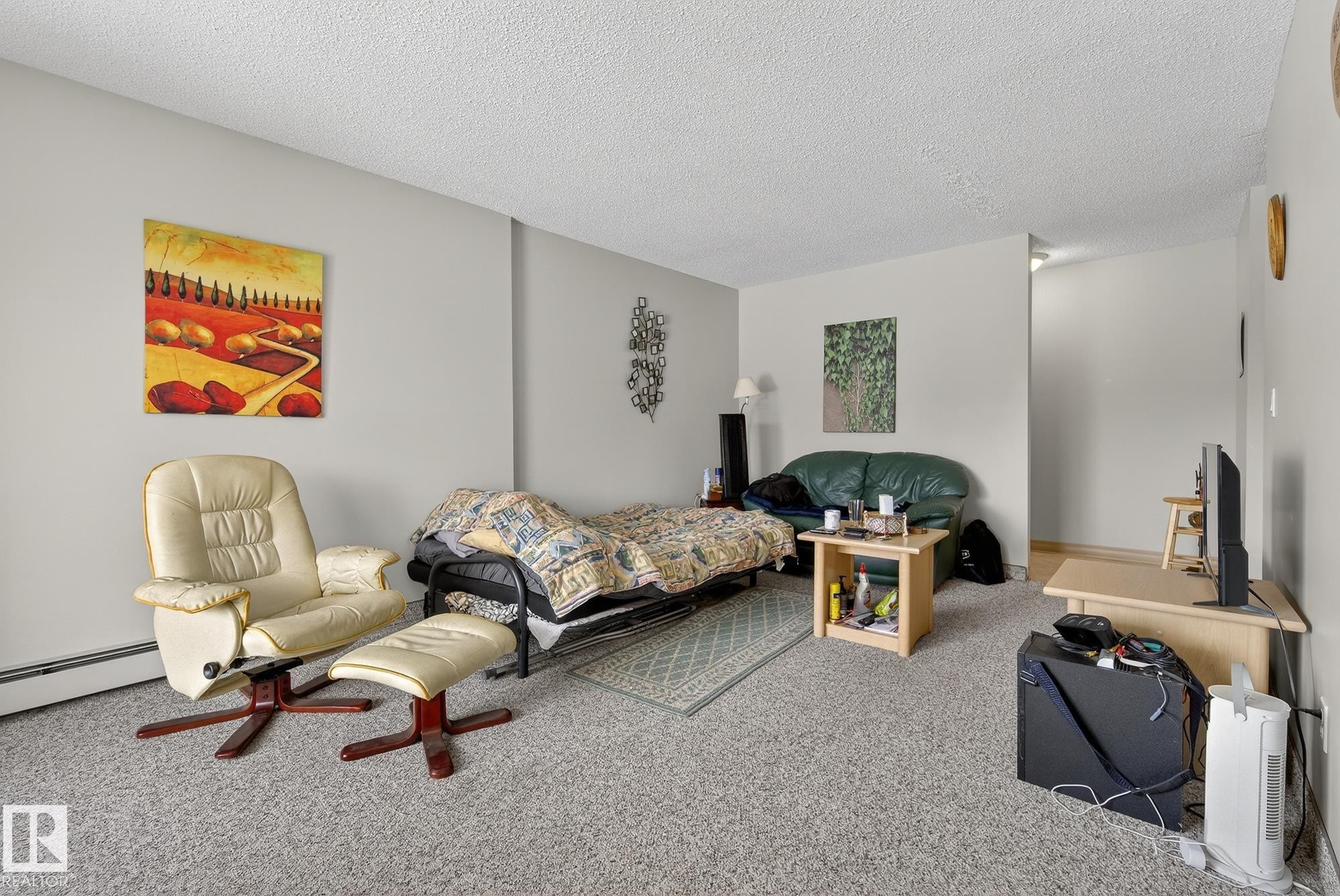 Carpeted bedroom with a textured ceiling - 302 4608 52 Avenue, Stony Plain, AB - Indoor