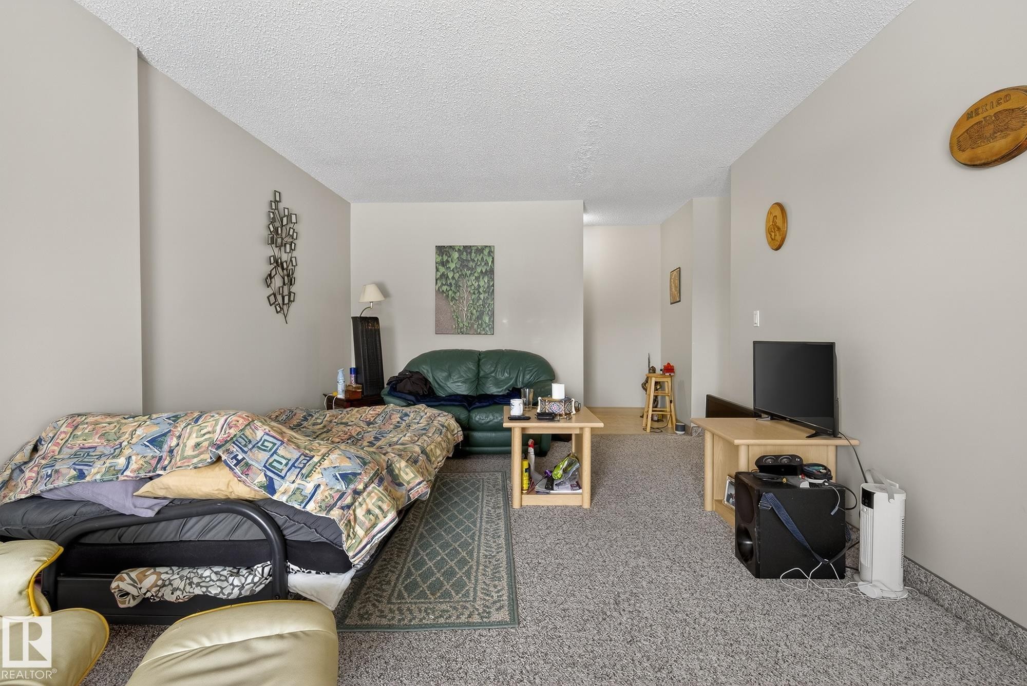Carpeted bedroom with a textured ceiling - 302 4608 52 Avenue, Stony Plain, AB - Indoor Photo Showing Bedroom