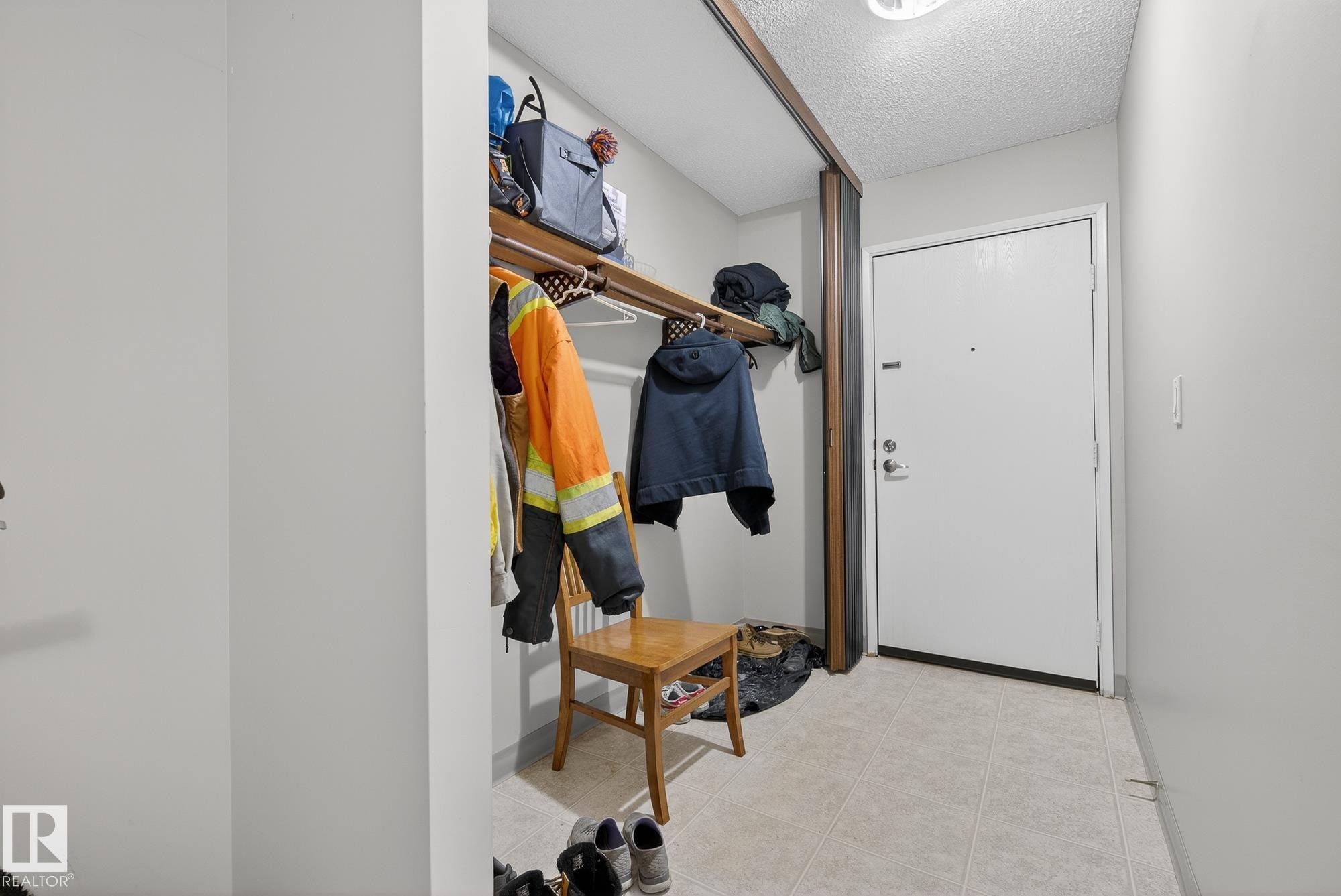 Doorway to outside with a textured ceiling - 302 4608 52 Avenue, Stony Plain, AB - Indoor Photo Showing Other Room