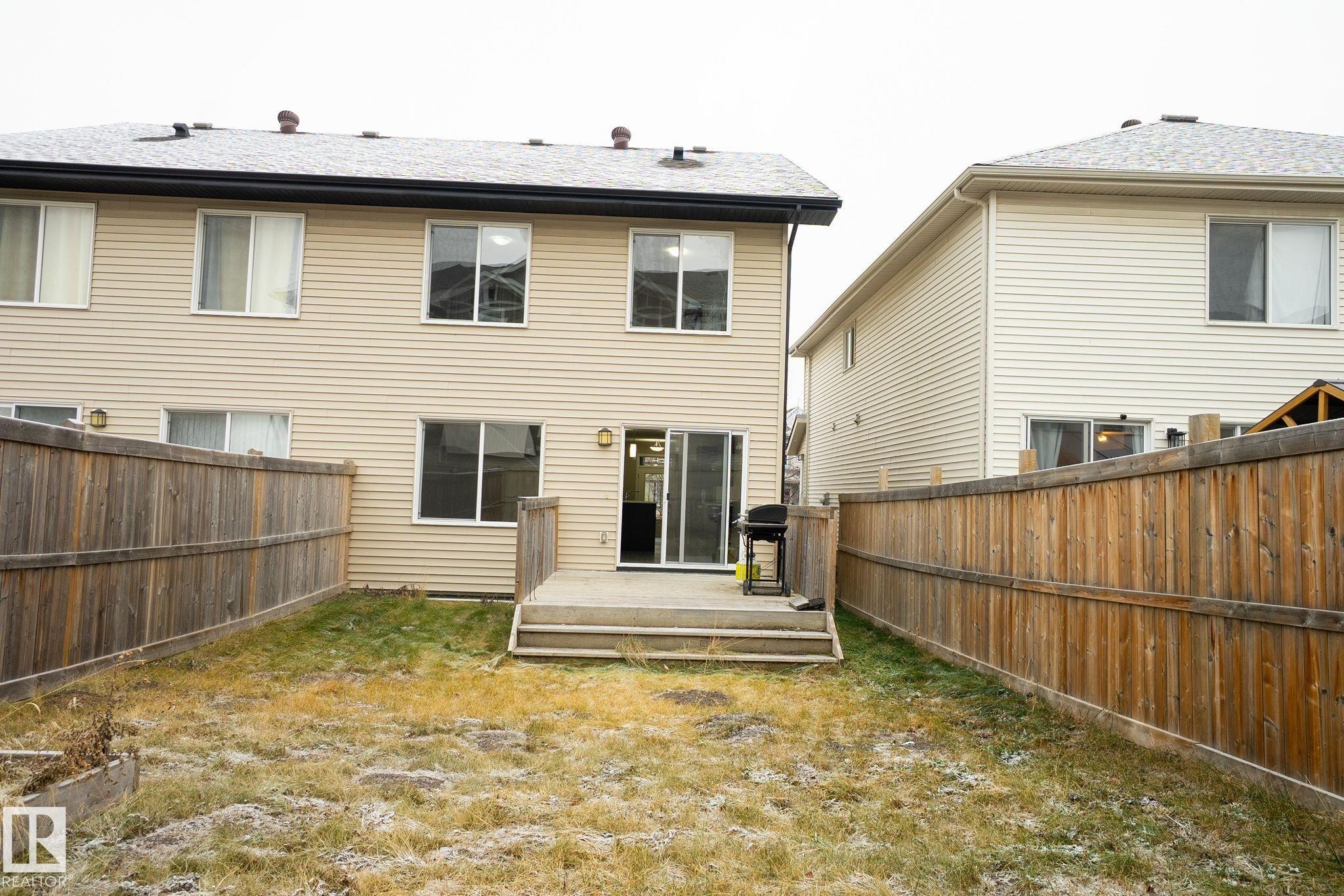 Rear view of property with a deck and a fenced backyard - Edmonton, AB - Outdoor With Exterior