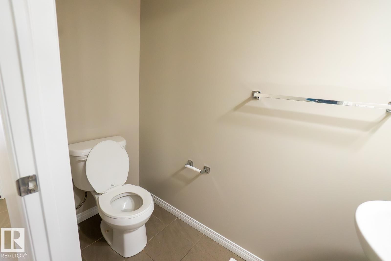 Bathroom featuring baseboards and tile patterned flooring - Edmonton, AB - Indoor Photo Showing Bathroom