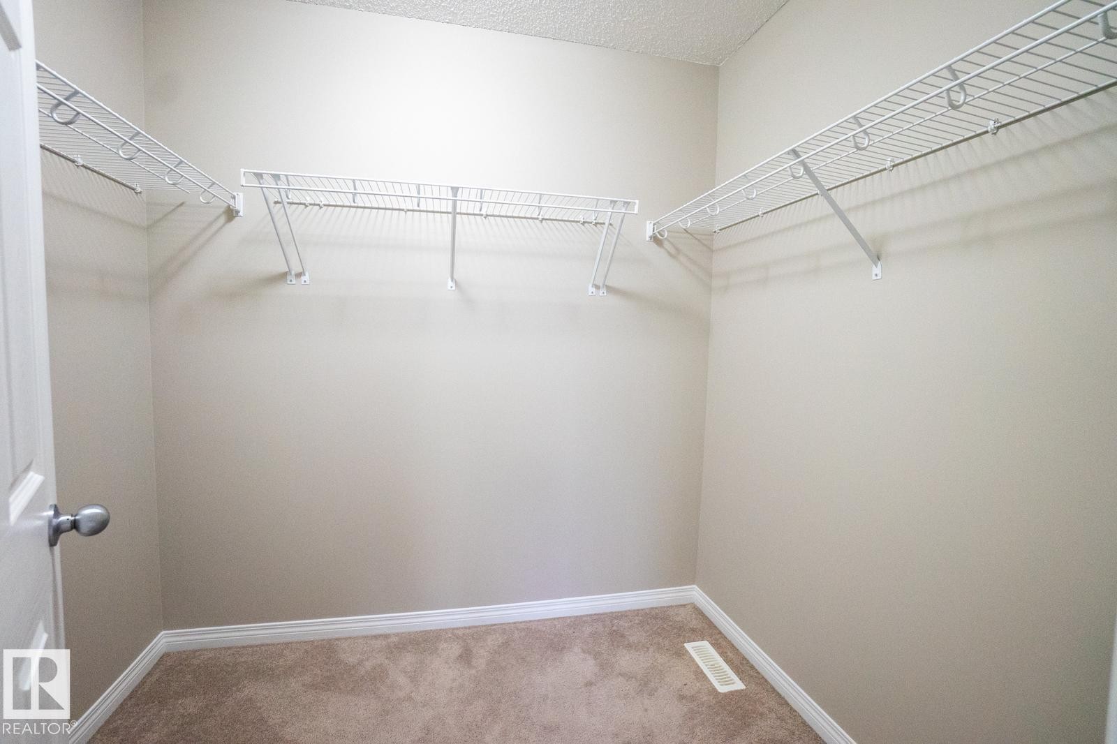 Spacious closet with light carpet - Edmonton, AB - Indoor With Storage