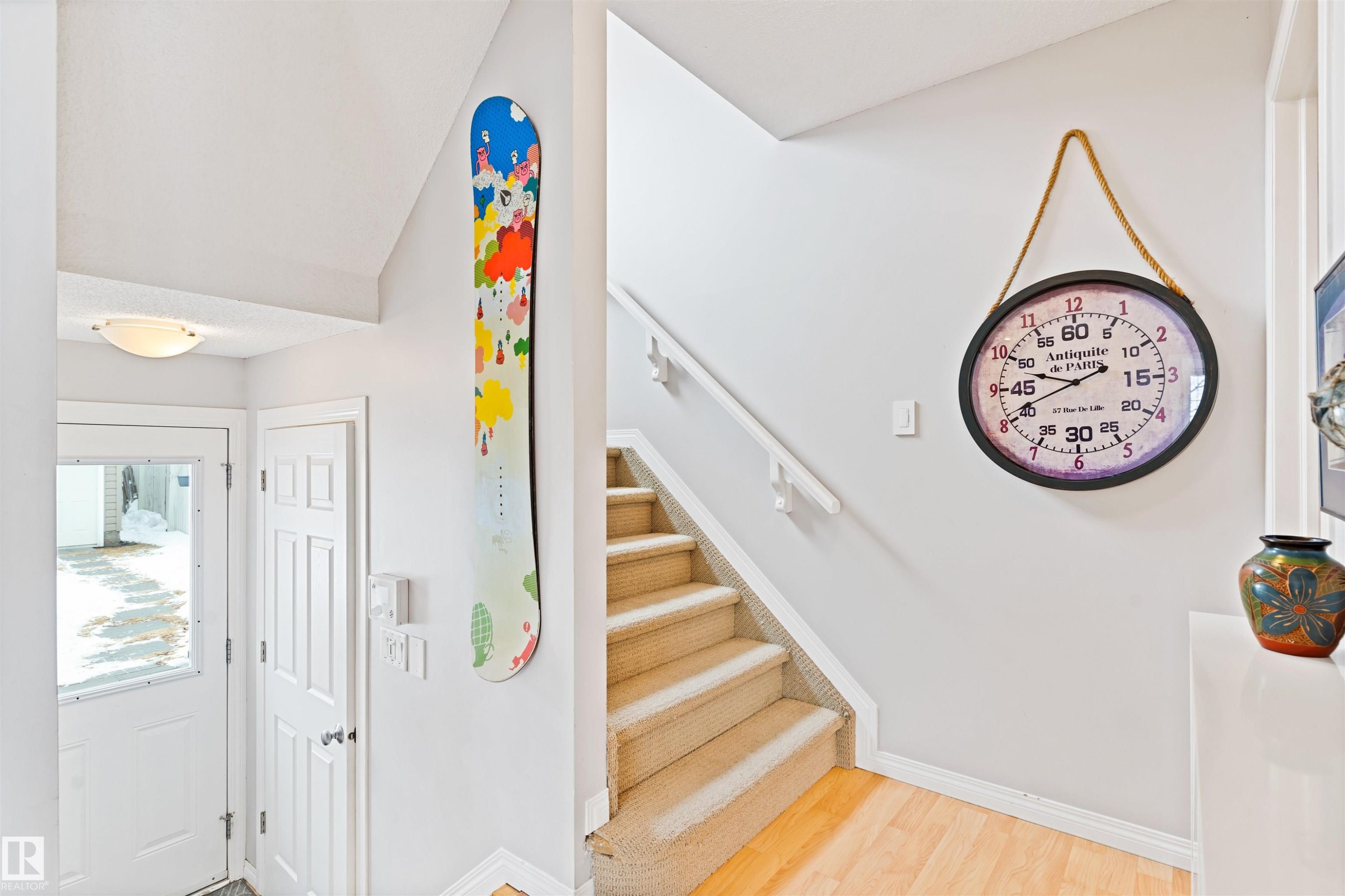 Stairway featuring baseboards and wood finished floors - 7804 Schmid Place, Edmonton, AB - Indoor Photo Showing Other Room