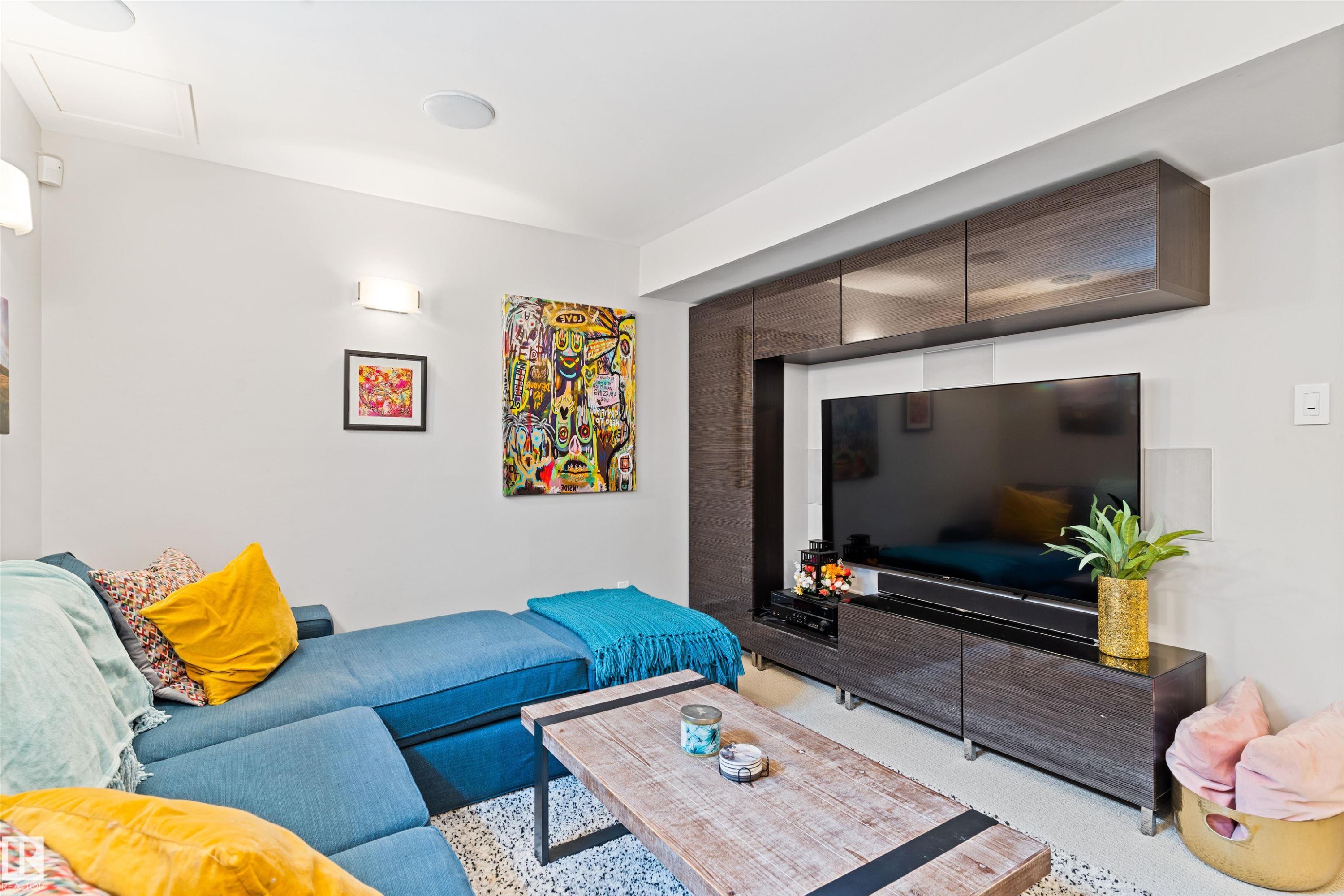 Carpeted living area with attic access - 7804 Schmid Place, Edmonton, AB - Indoor Photo Showing Living Room