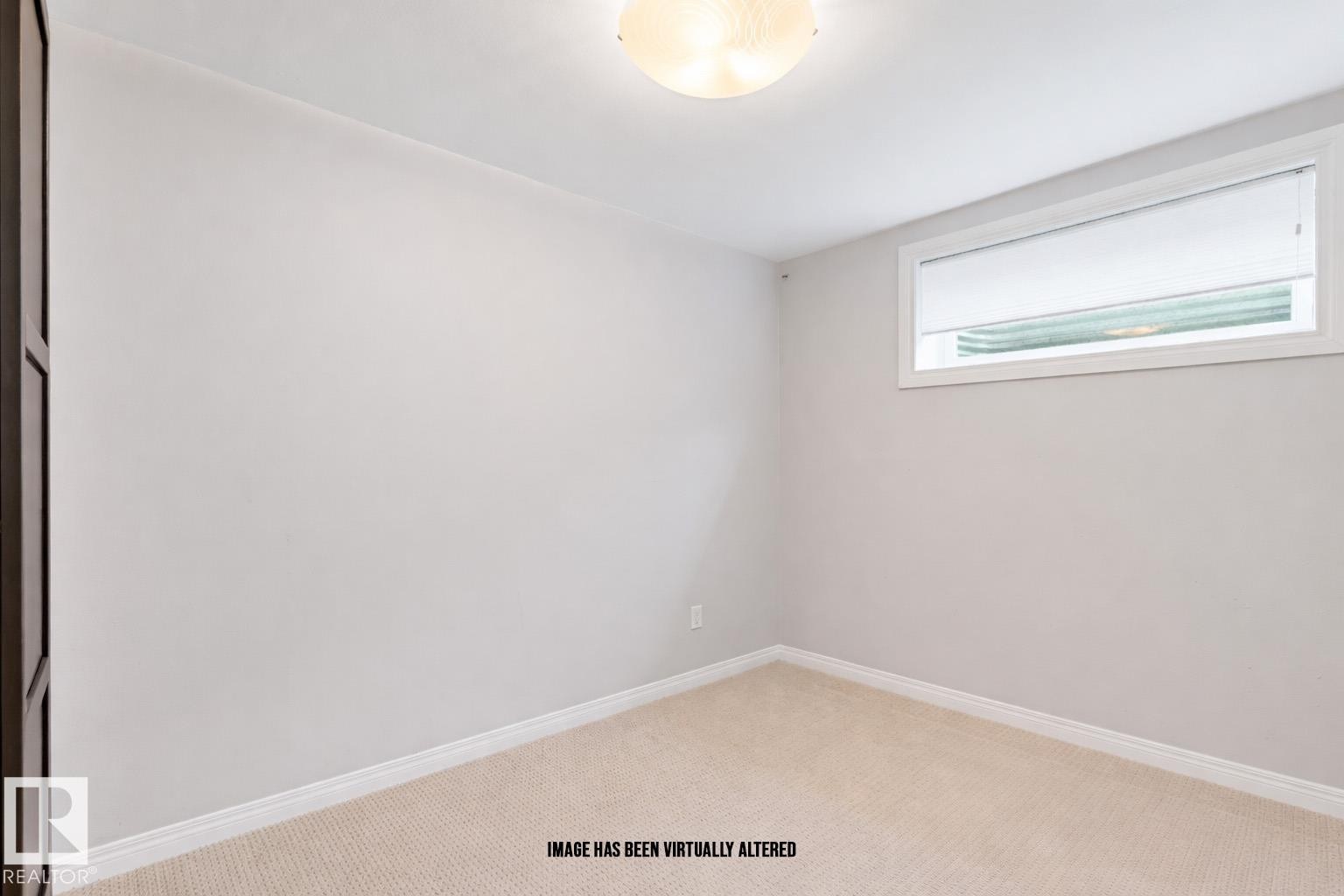 Unfurnished room featuring light carpet and baseboards - 7804 Schmid Place, Edmonton, AB - Indoor Photo Showing Other Room