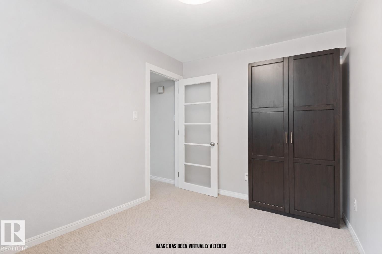 Unfurnished bedroom featuring light colored carpet and baseboards - 7804 Schmid Place, Edmonton, AB - Indoor Photo Showing Other Room