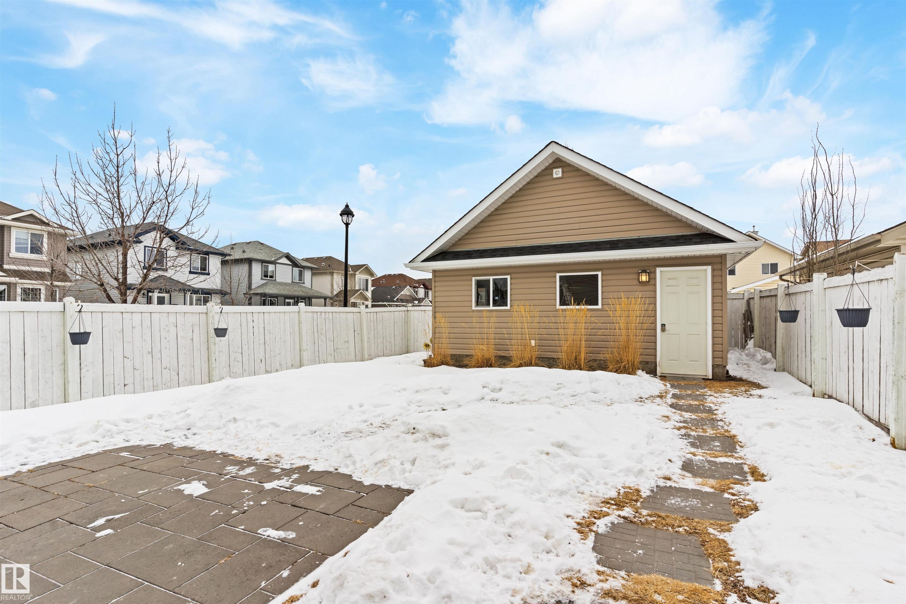 Rear view of house with a fenced backyard and a residential view - 7804 Schmid Place, Edmonton, AB - Outdoor