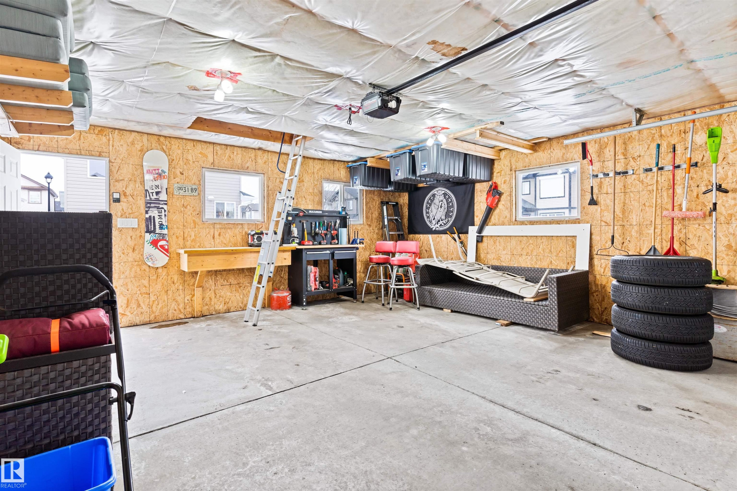 Garage featuring a garage door opener and a workshop area - 7804 Schmid Place, Edmonton, AB - Indoor Photo Showing Garage