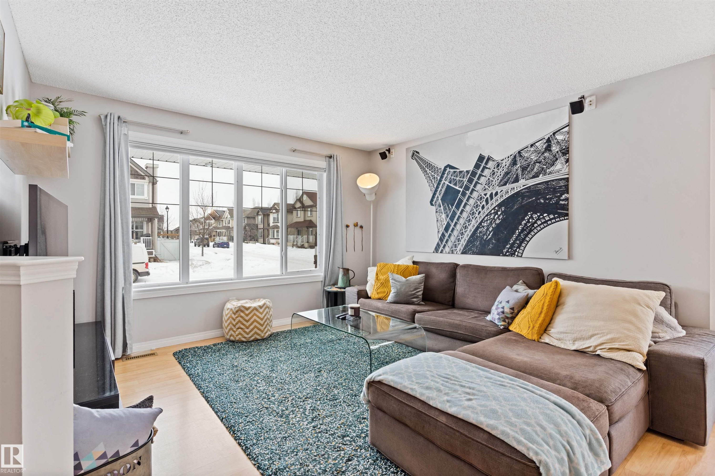 Living area with light wood-type flooring and a textured ceiling - 7804 Schmid Place, Edmonton, AB - Indoor Photo Showing Living Room