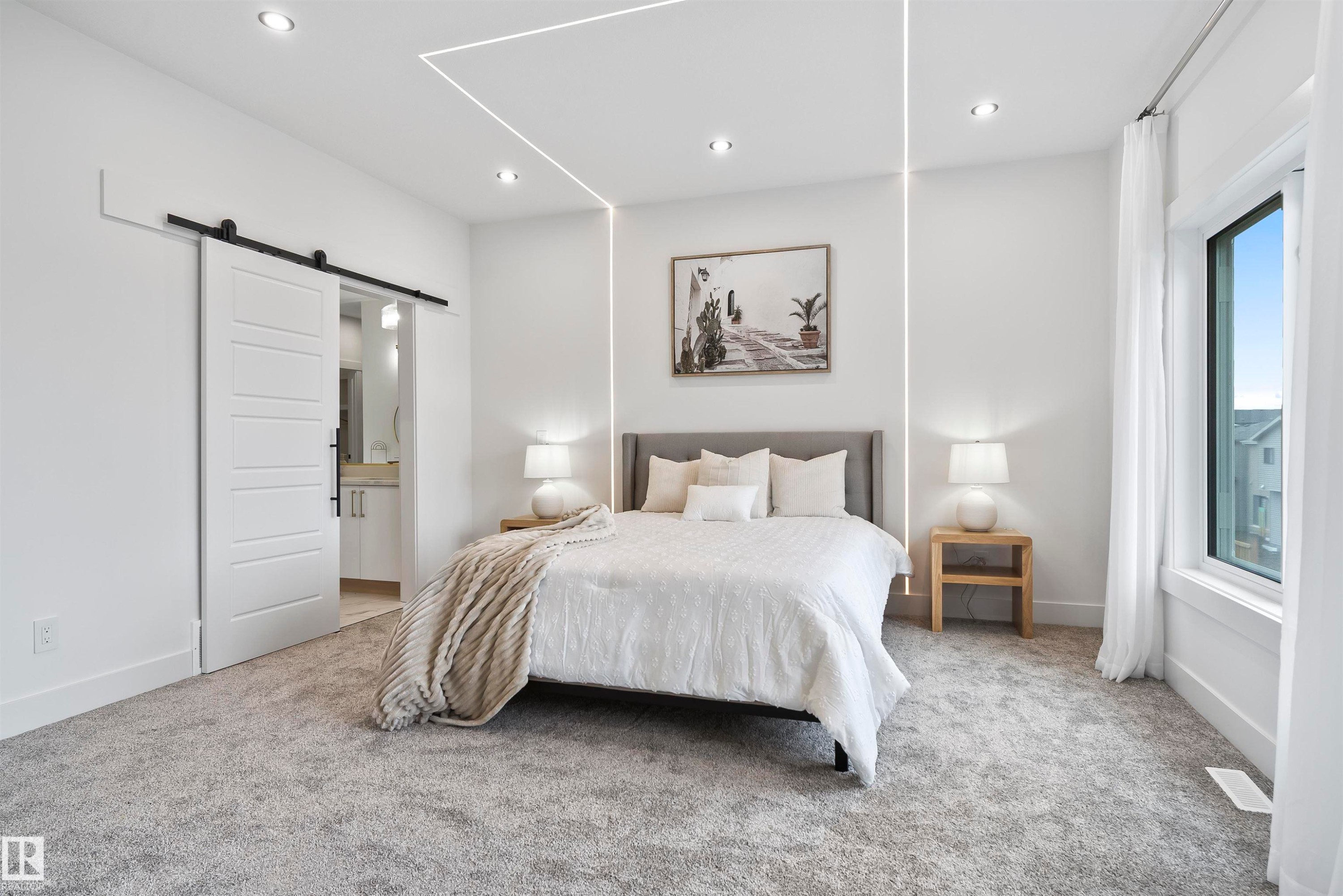 Carpeted bedroom with a barn door, recessed lighting, and ensuite bath - 13152 187 Avenue, Edmonton, AB - Indoor Photo Showing Bedroom