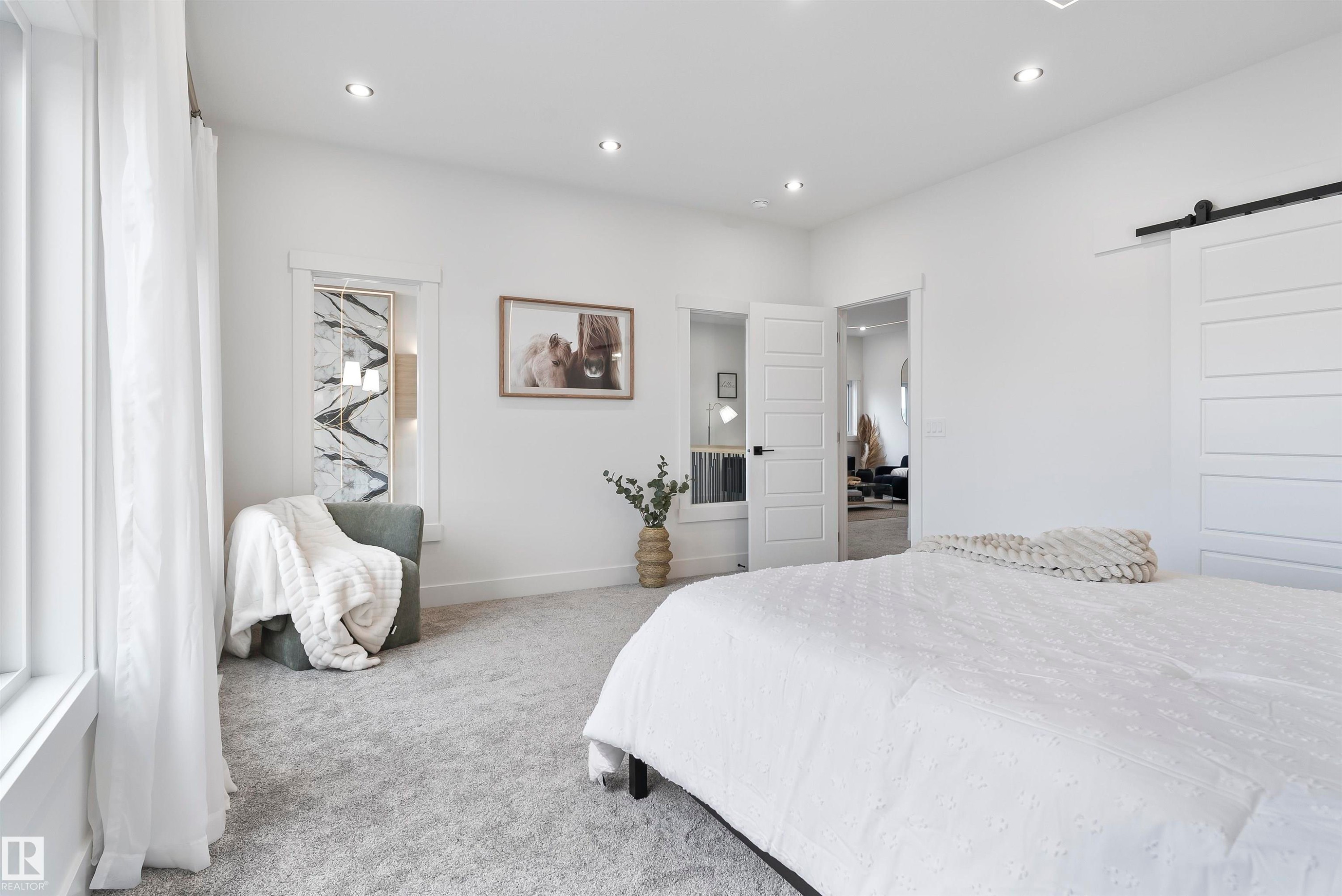 Bedroom with a barn door, carpet flooring, and recessed lighting - 13152 187 Avenue, Edmonton, AB - Indoor Photo Showing Bedroom