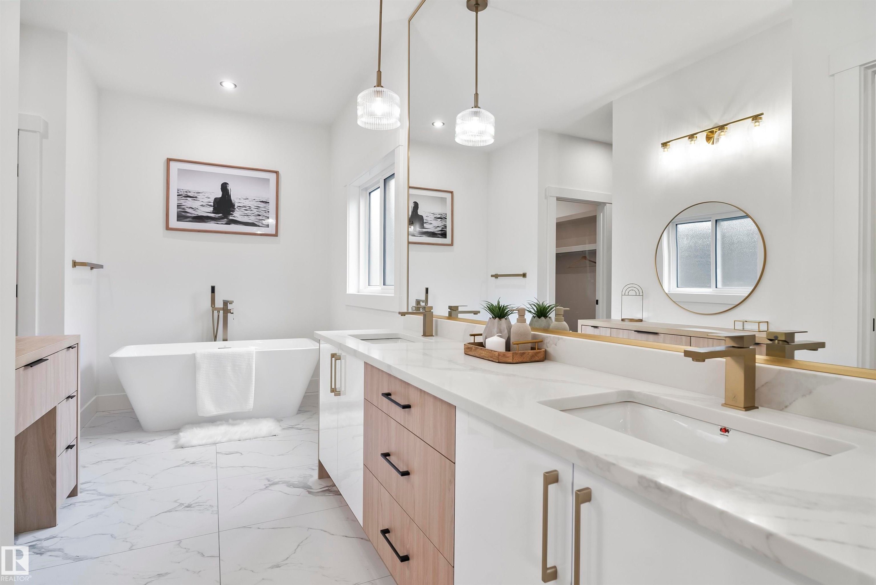 Full bath featuring double vanity, light marble finish flooring, and a freestanding bath - 13152 187 Avenue, Edmonton, AB - Indoor Photo Showing Bathroom