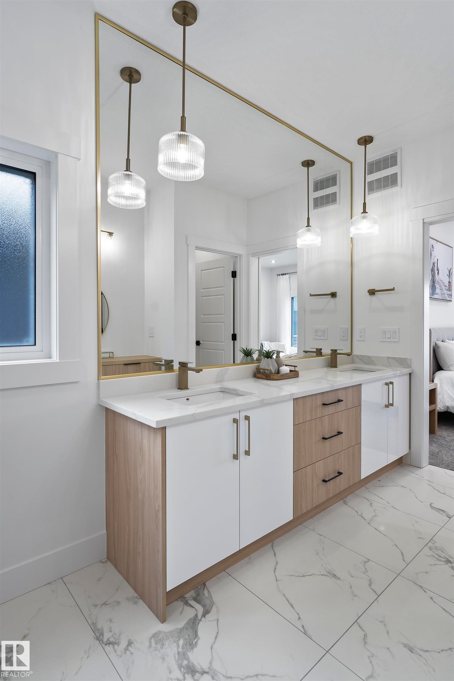 Bathroom featuring double vanity, light marble finish flooring, and connected bathroom - 13152 187 Avenue, Edmonton, AB - Indoor Photo Showing Bathroom