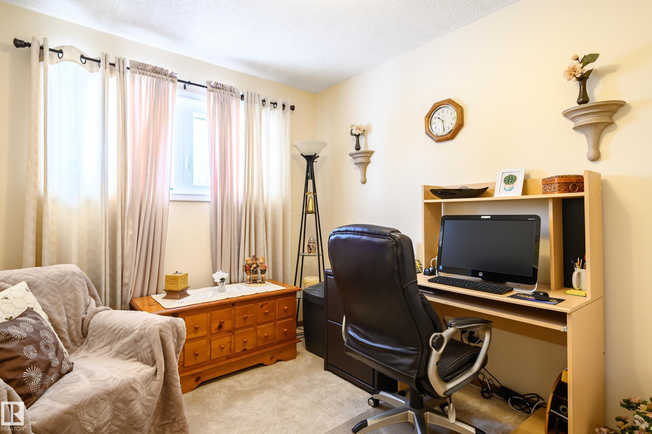 Office area featuring light carpet and a textured ceiling - 13420 113A St, Edmonton, AB - Indoor Photo Showing Office
