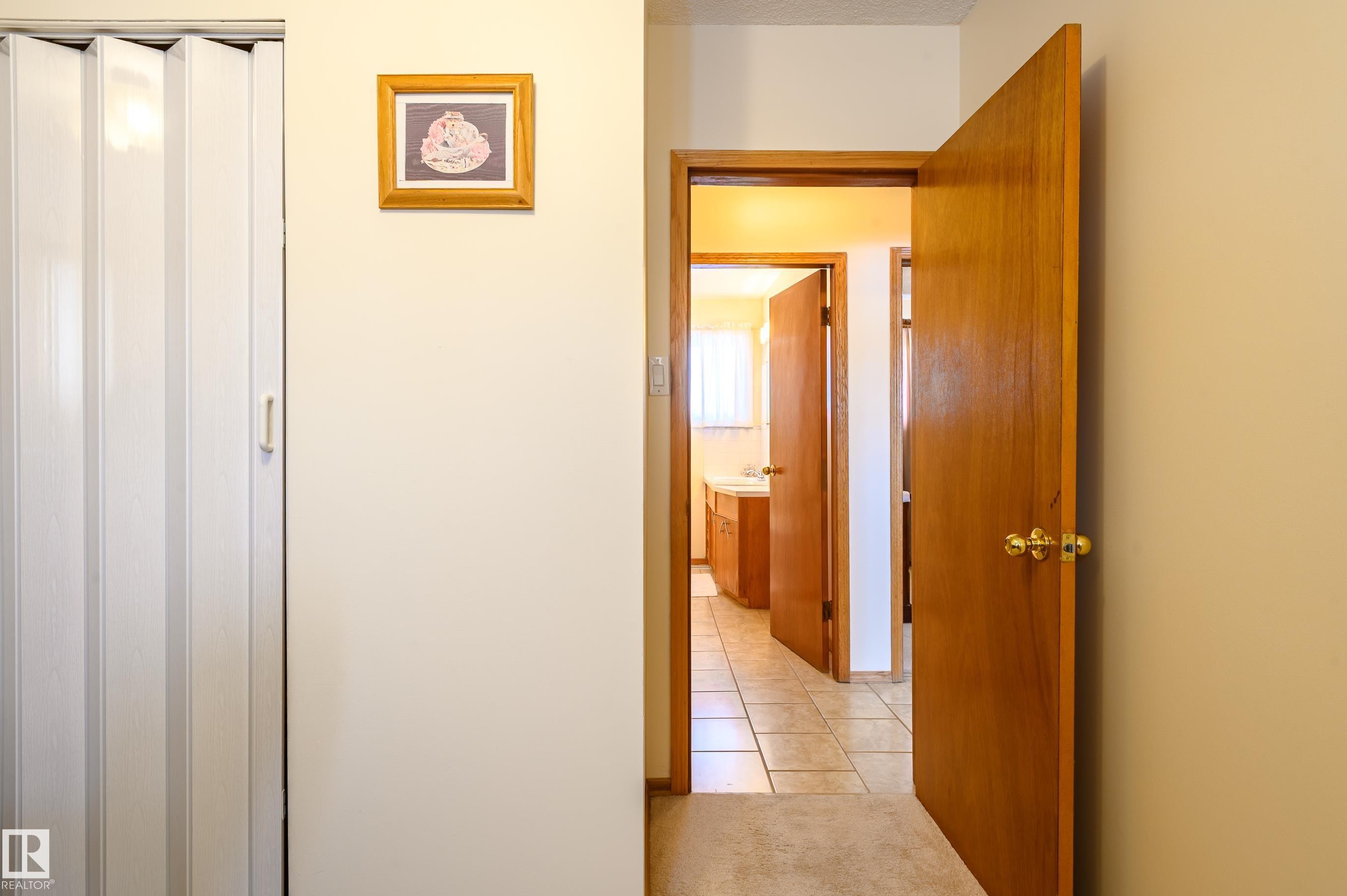 Hall featuring light tile patterned floors and a textured ceiling - 13420 113A St, Edmonton, AB - Indoor Photo Showing Other Room