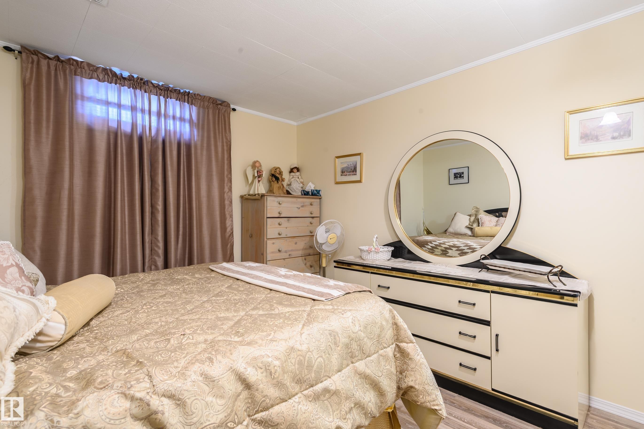 Bedroom featuring light wood-type flooring and ornamental molding - 13420 113A St, Edmonton, AB - Indoor Photo Showing Bedroom
