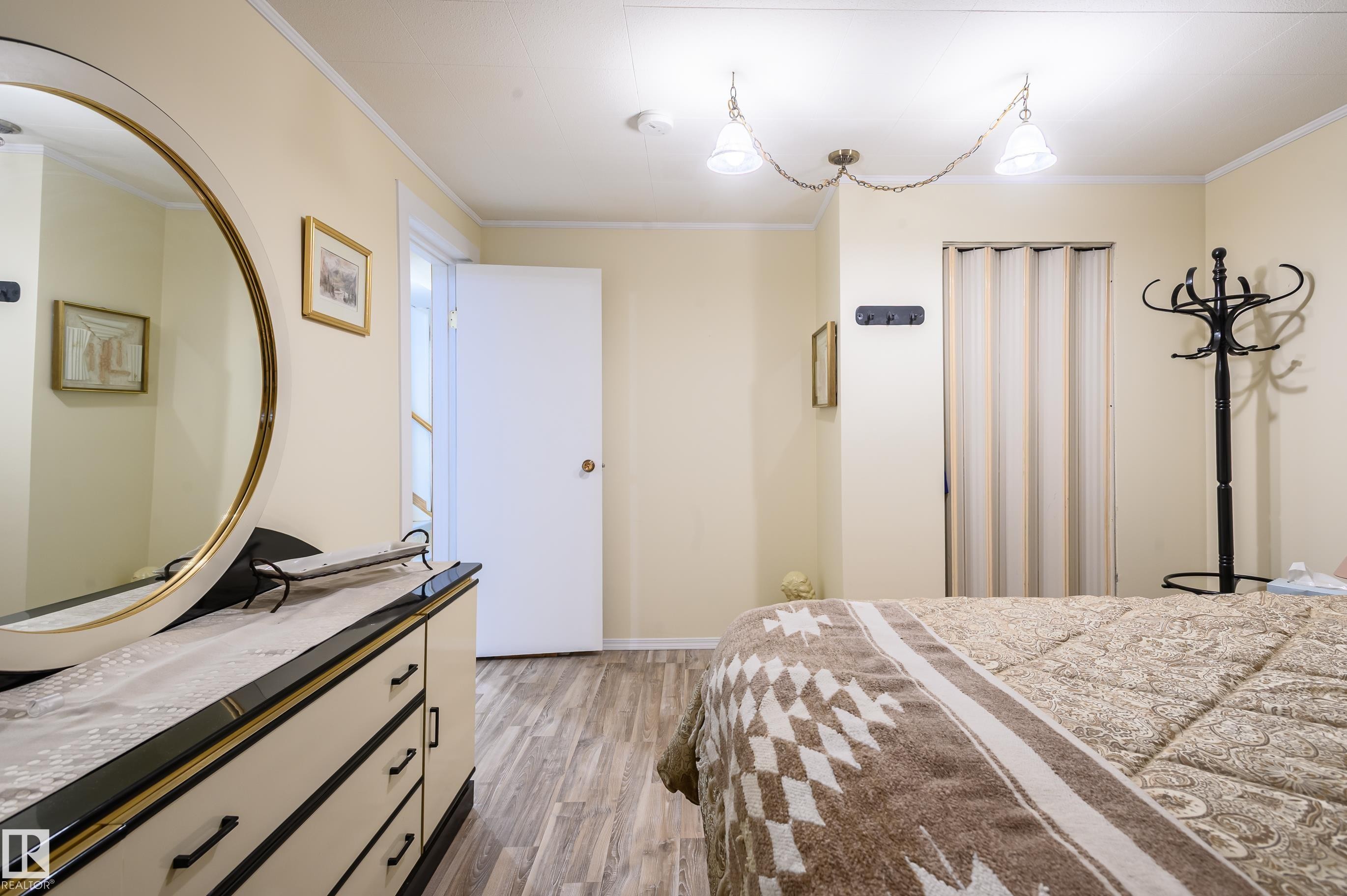 Bedroom with light wood-style floors and crown molding - 13420 113A St, Edmonton, AB - Indoor