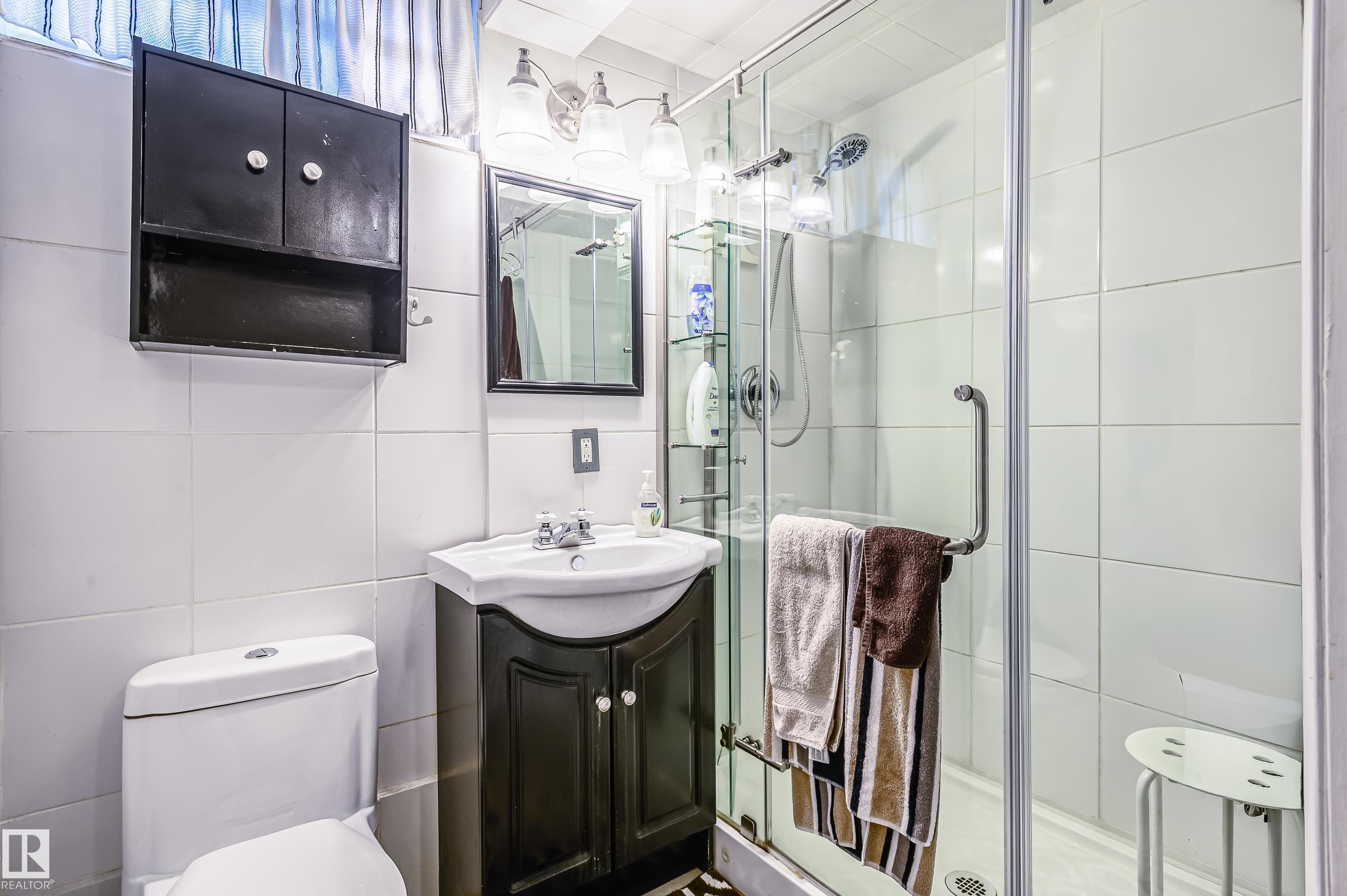 Bathroom with vanity, tile walls, and a stall shower - 13420 113A St, Edmonton, AB - Indoor Photo Showing Bathroom