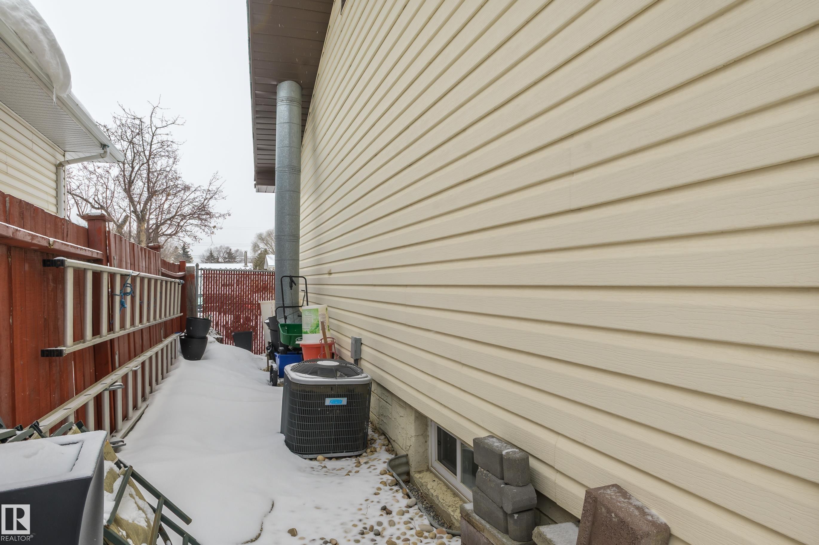 View of property exterior featuring a cooling unit - 13420 113A St, Edmonton, AB - Outdoor With Exterior