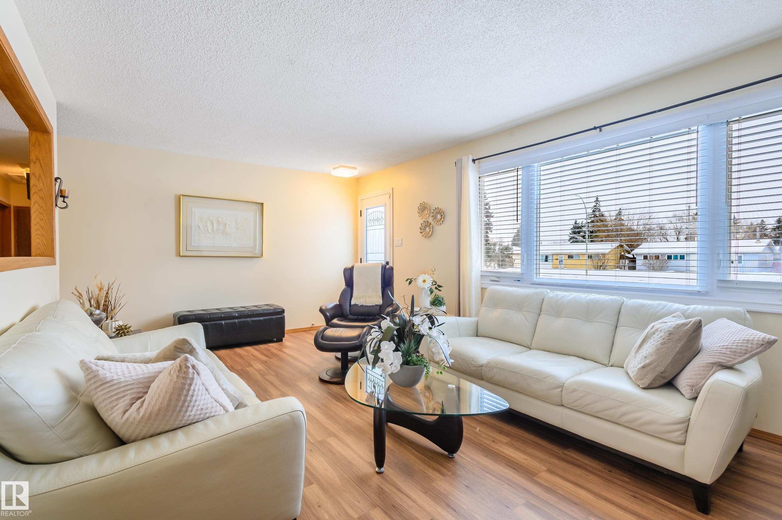 Living room featuring light wood-style floors and a textured ceiling - 13420 113A St, Edmonton, AB - Indoor Photo Showing Living Room