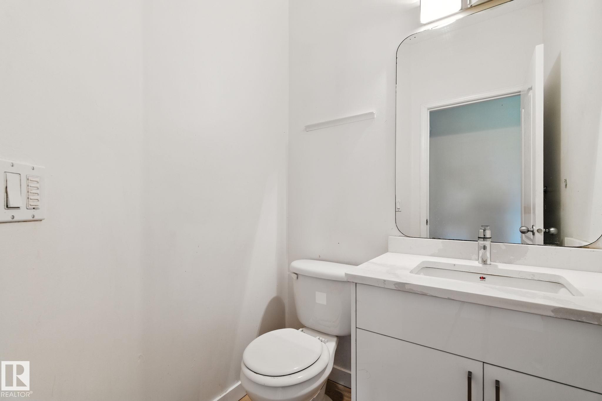 Bathroom featuring vanity and toilet - 7836 7 Avenue, Edmonton, AB - Indoor Photo Showing Bathroom