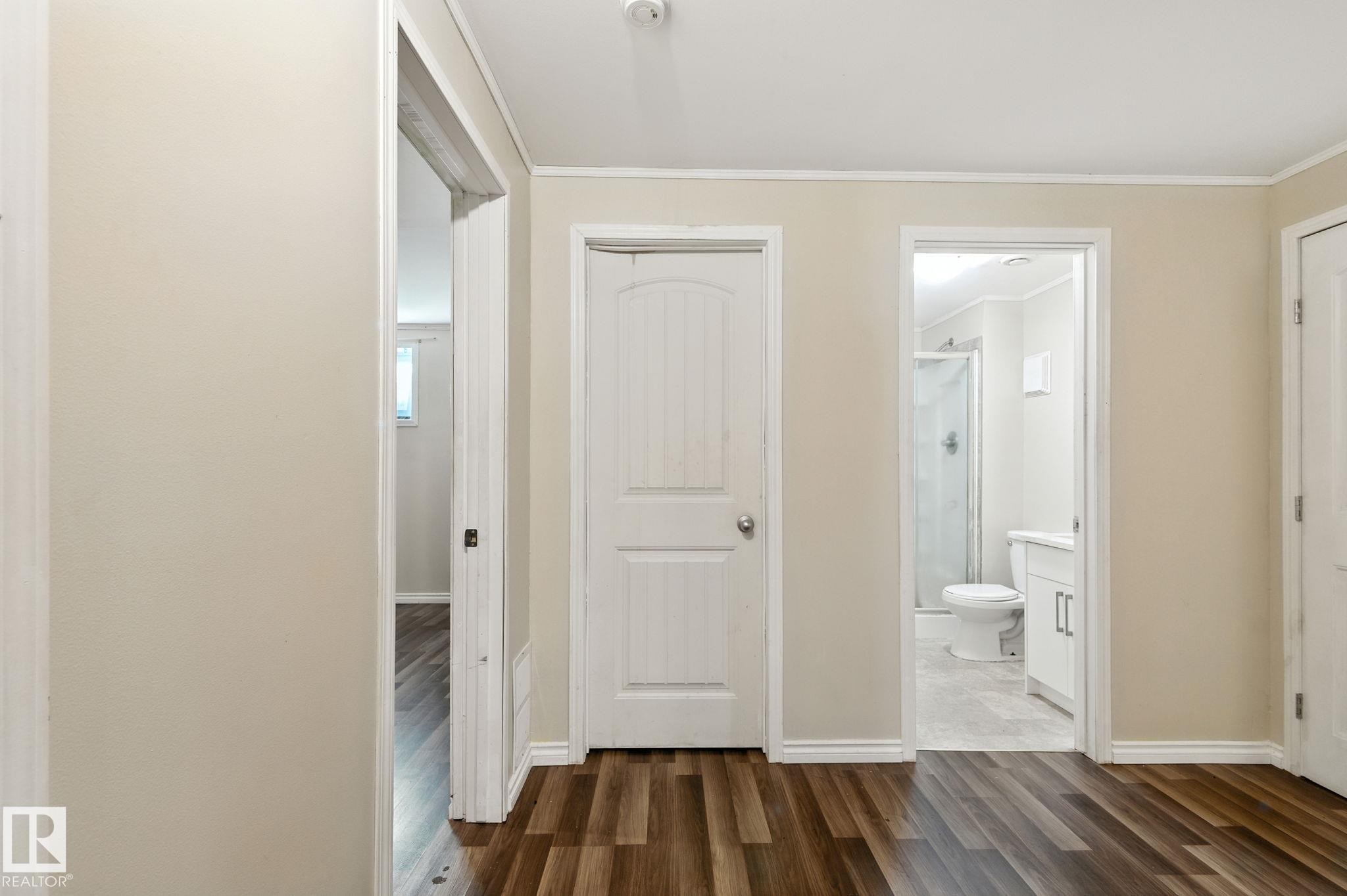 Hallway with crown molding and dark wood-style flooring - 7836 7 Avenue, Edmonton, AB - Indoor Photo Showing Other Room