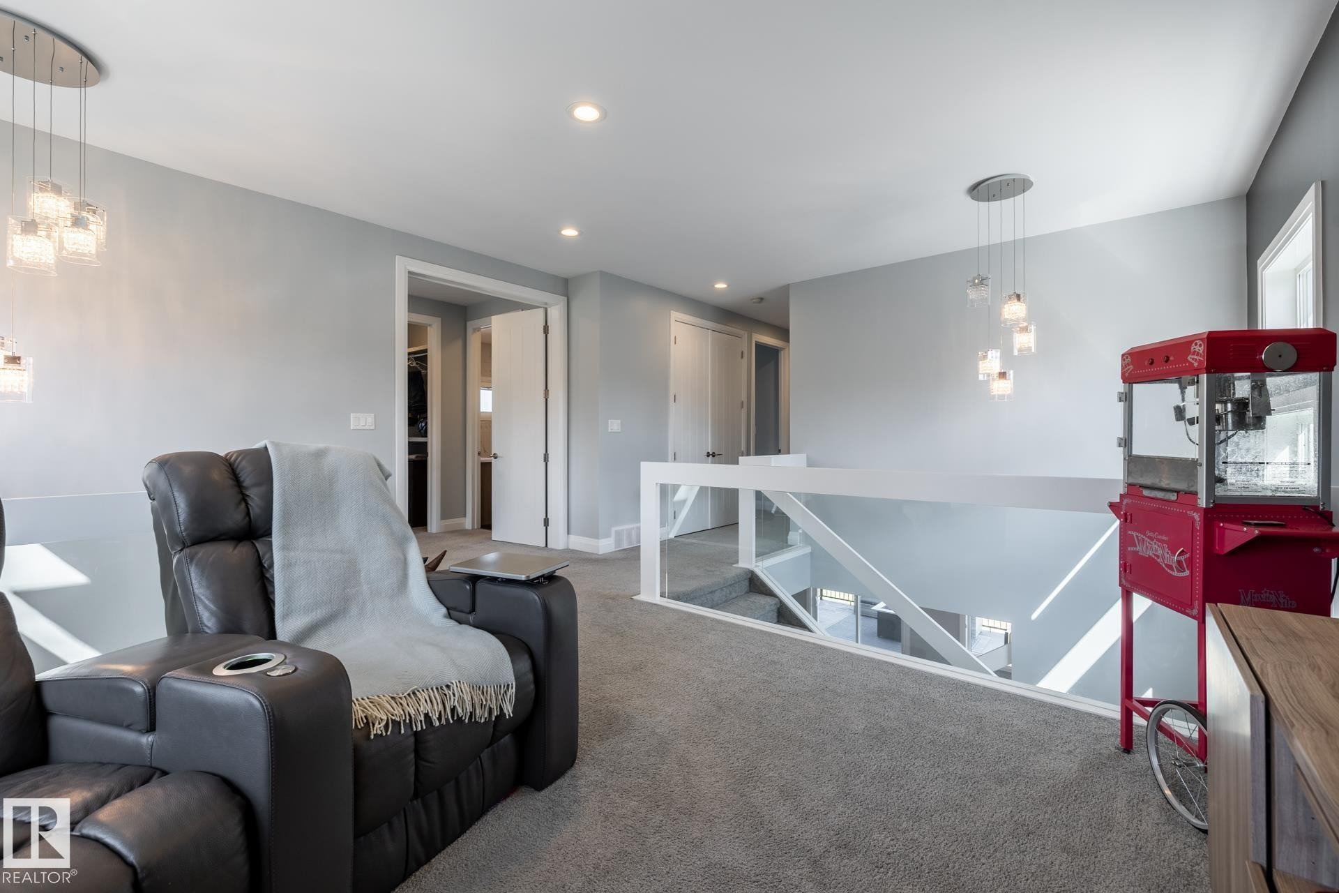 Carpeted living area with recessed lighting and a chandelier - 10936 71 Avenue, Edmonton, AB - Indoor