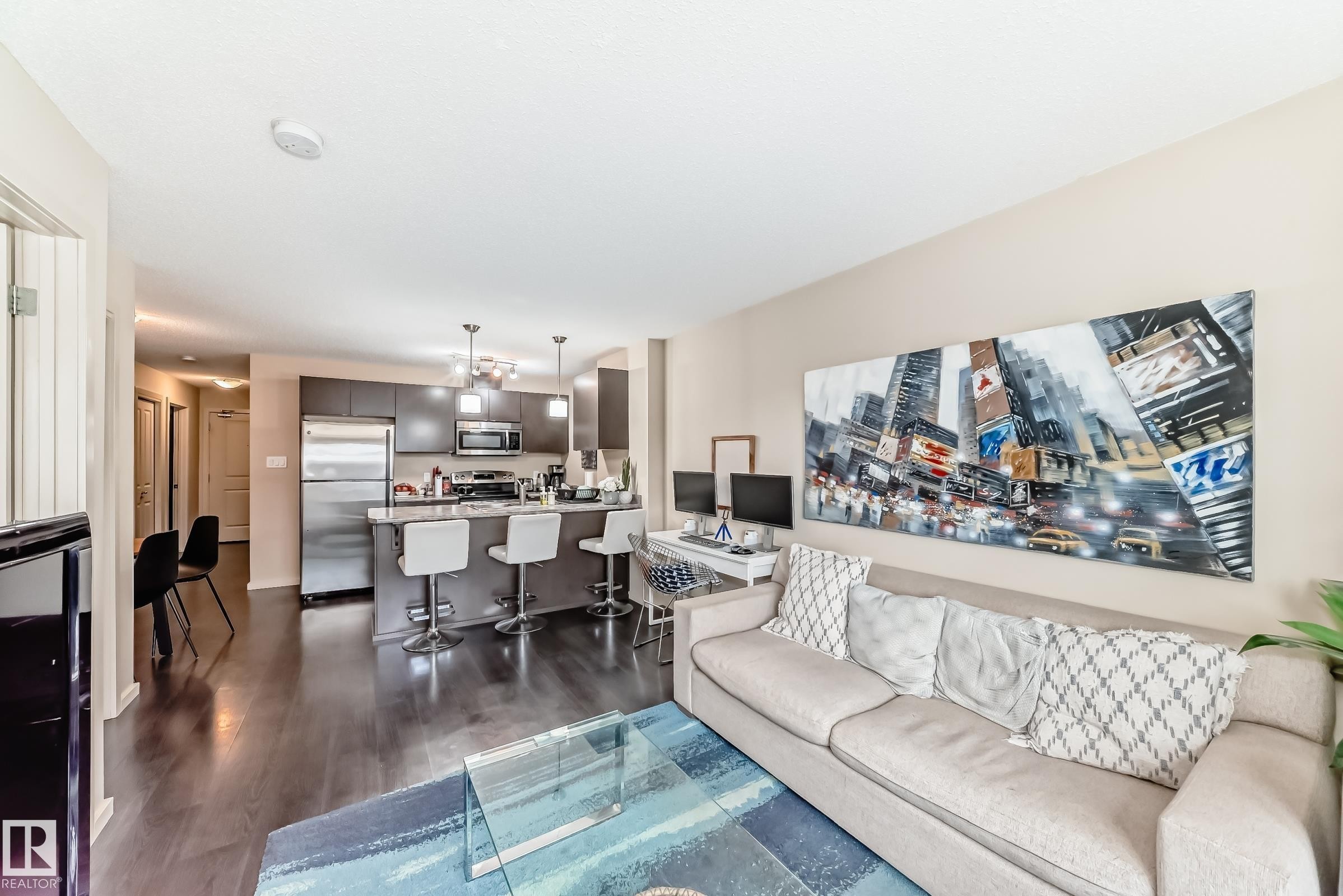 Living room featuring dark wood finished floors - 403 340 Windermere Road, Edmonton, AB - Indoor Photo Showing Living Room