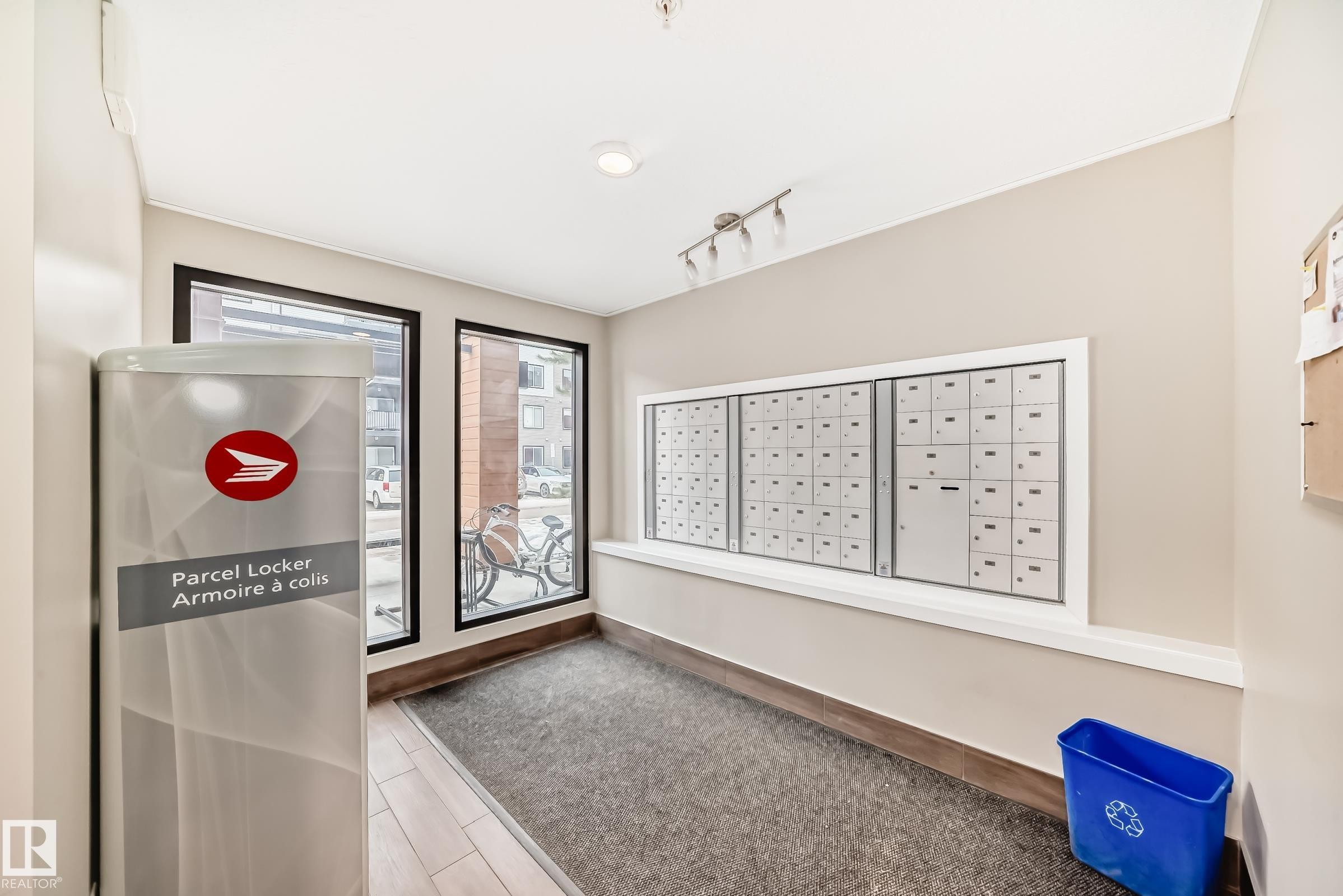 View of property's community with mail area and rail lighting - 403 340 Windermere Road, Edmonton, AB - Indoor Photo Showing Other Room