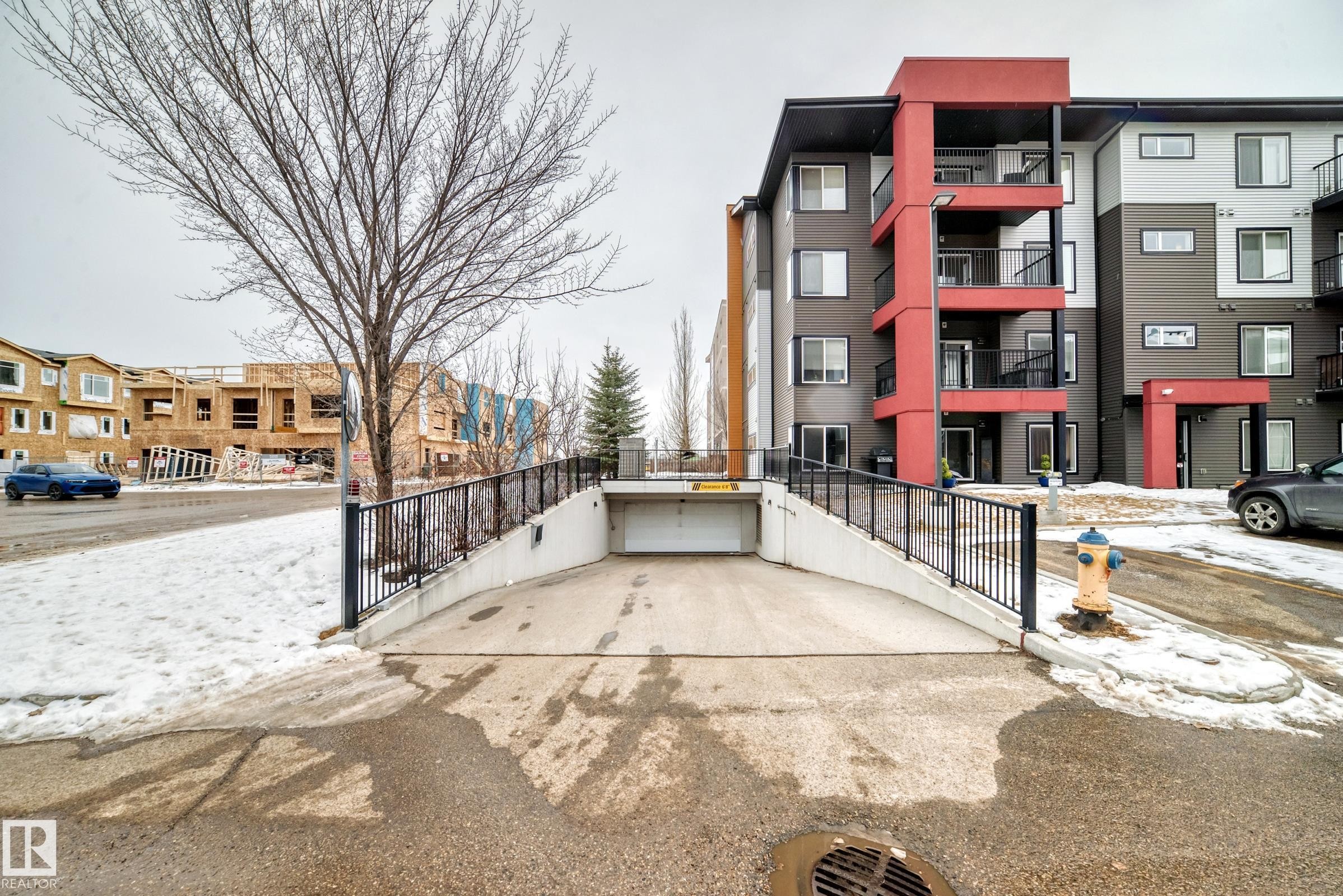 Snow covered building featuring a view of apartment building / complex - 403 340 Windermere Road, Edmonton, AB - Outdoor