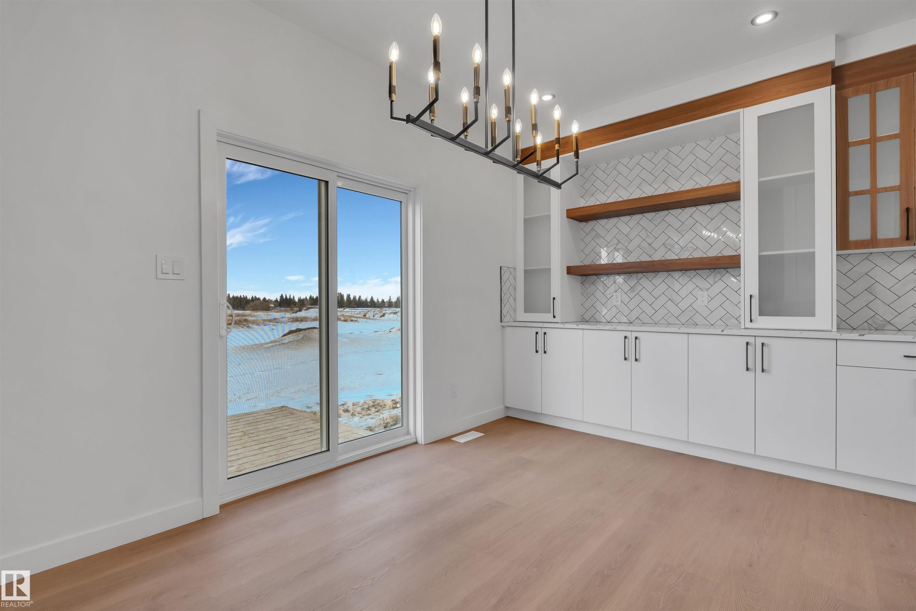Unfurnished dining area with light wood-style floors and a chandelier - 34 Grayson Green, Stony Plain, AB - Indoor Photo Showing Other Room