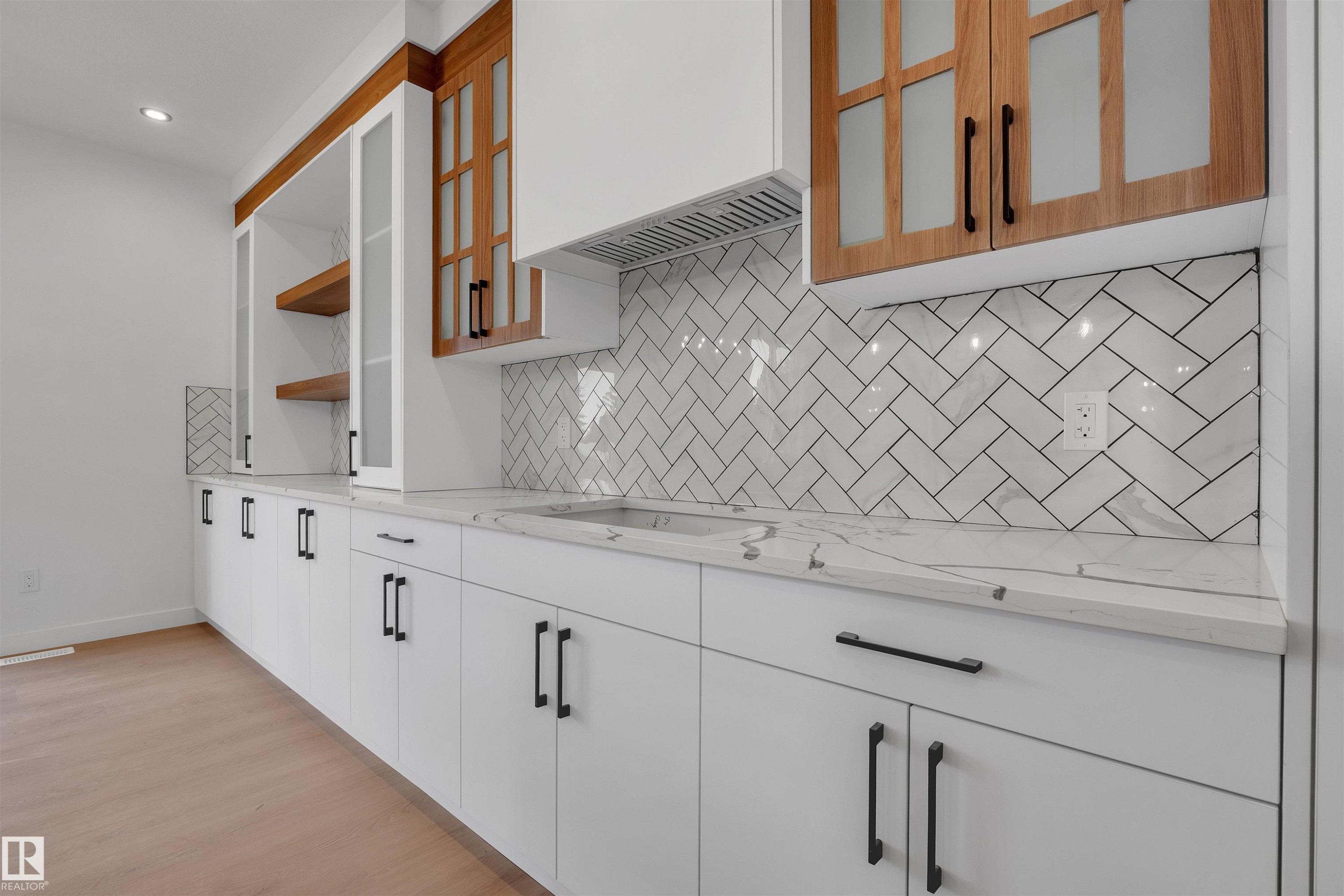 Kitchen with white cabinetry, custom exhaust hood, open shelves, light wood-style floors, and light stone countertops - 34 Grayson Green, Stony Plain, AB - Indoor