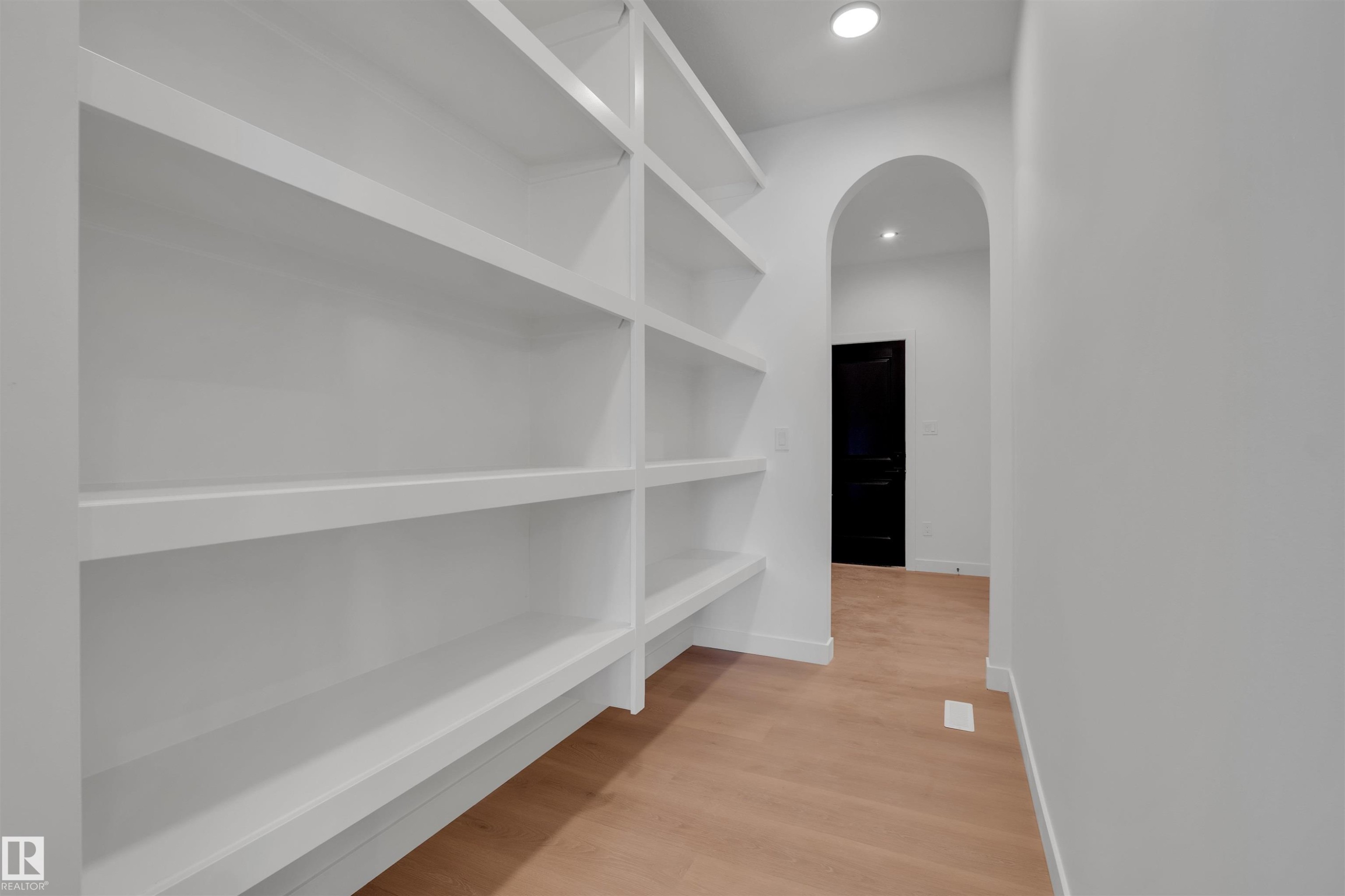 Hallway featuring arched walkways, light wood-type flooring, and recessed lighting - 34 Grayson Green, Stony Plain, AB - Indoor With Storage