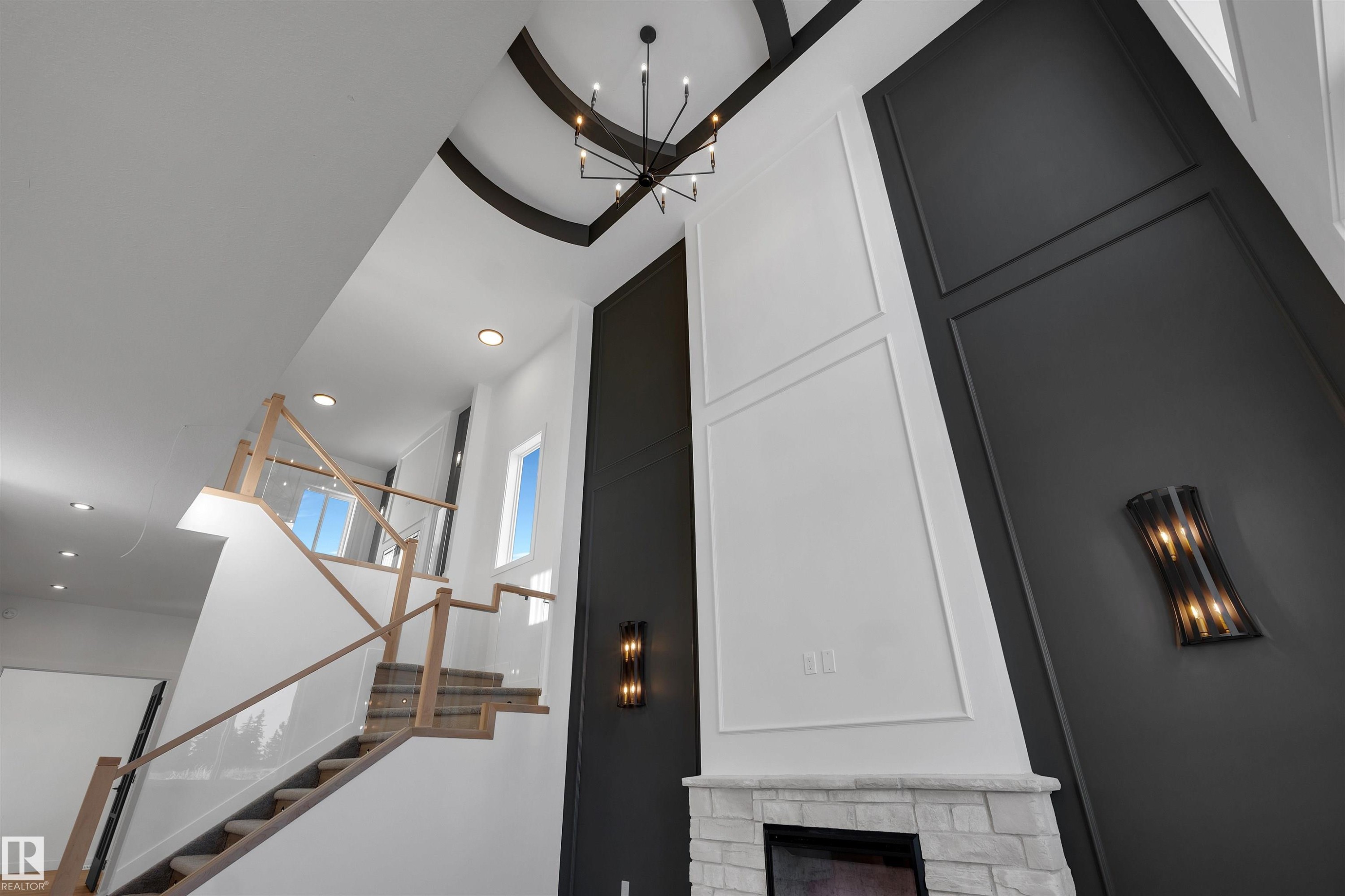 Detailed view of a stone fireplace, recessed lighting, a chandelier, and a decorative wall - 34 Grayson Green, Stony Plain, AB - Indoor Photo Showing Other Room
