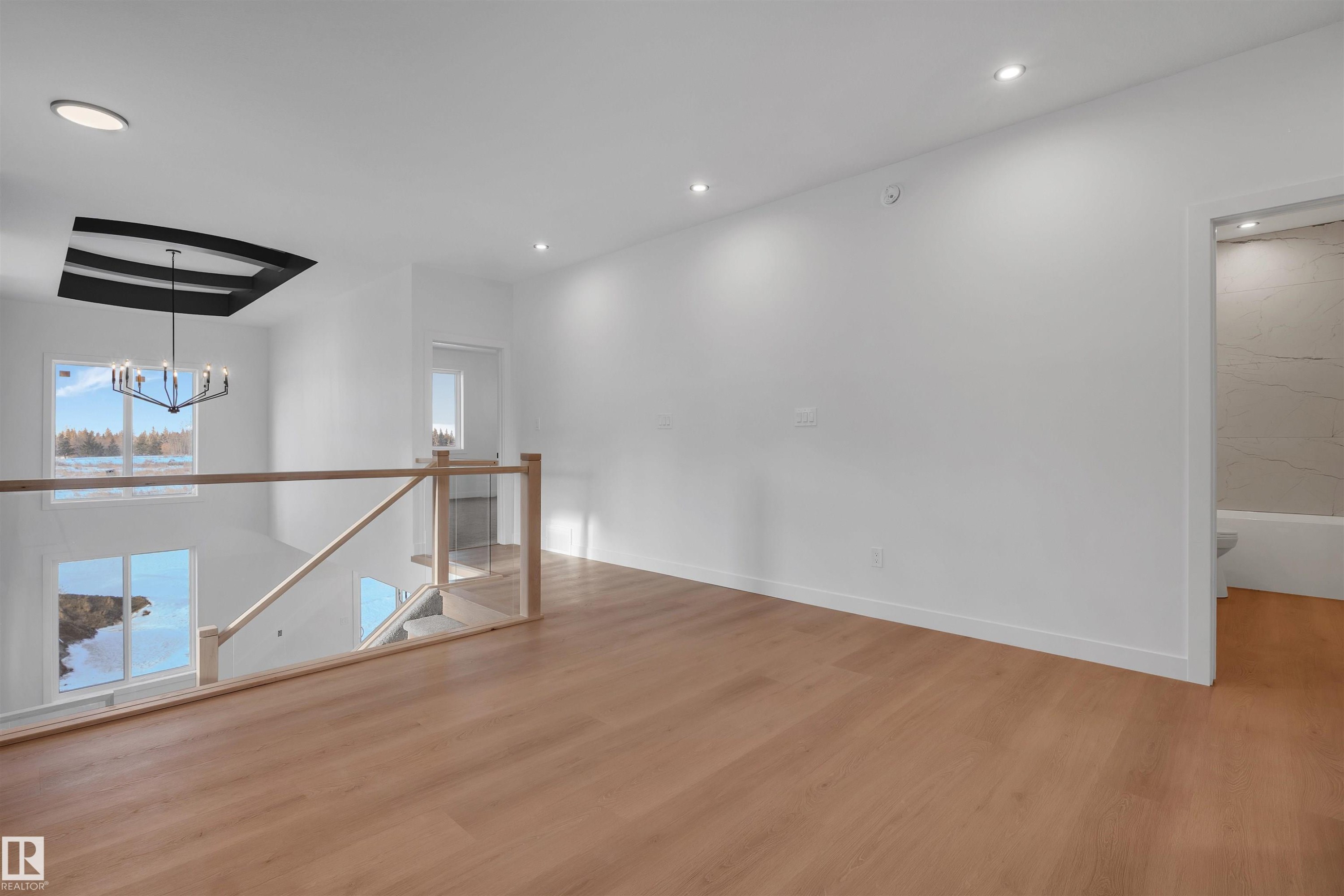 Unfurnished room with a chandelier, light wood finished floors, and recessed lighting - 34 Grayson Green, Stony Plain, AB - Indoor Photo Showing Other Room