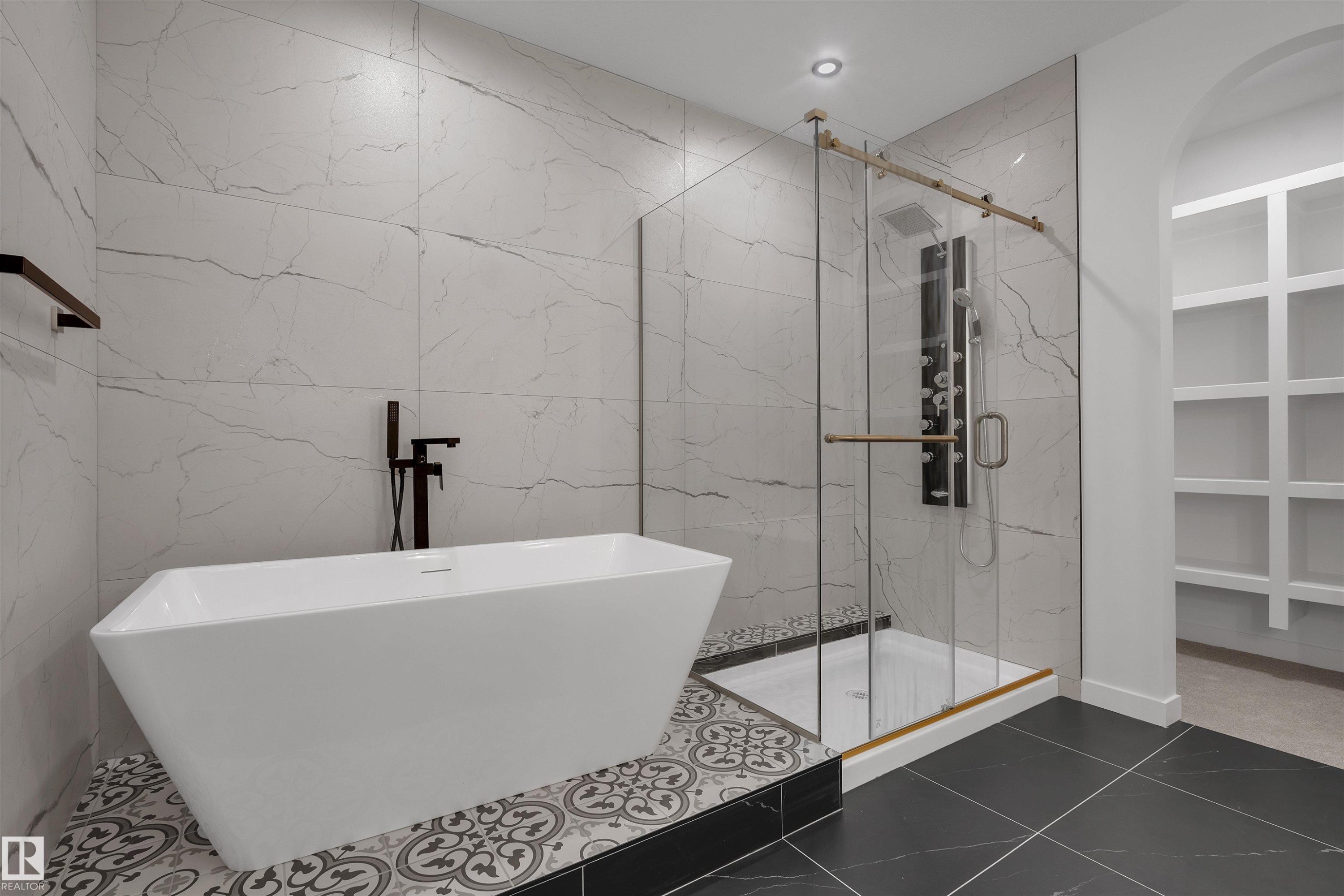 Bathroom with tile walls, a freestanding tub, a marble finish shower, dark tile patterned floors, and recessed lighting - 34 Grayson Green, Stony Plain, AB - Indoor Photo Showing Bathroom