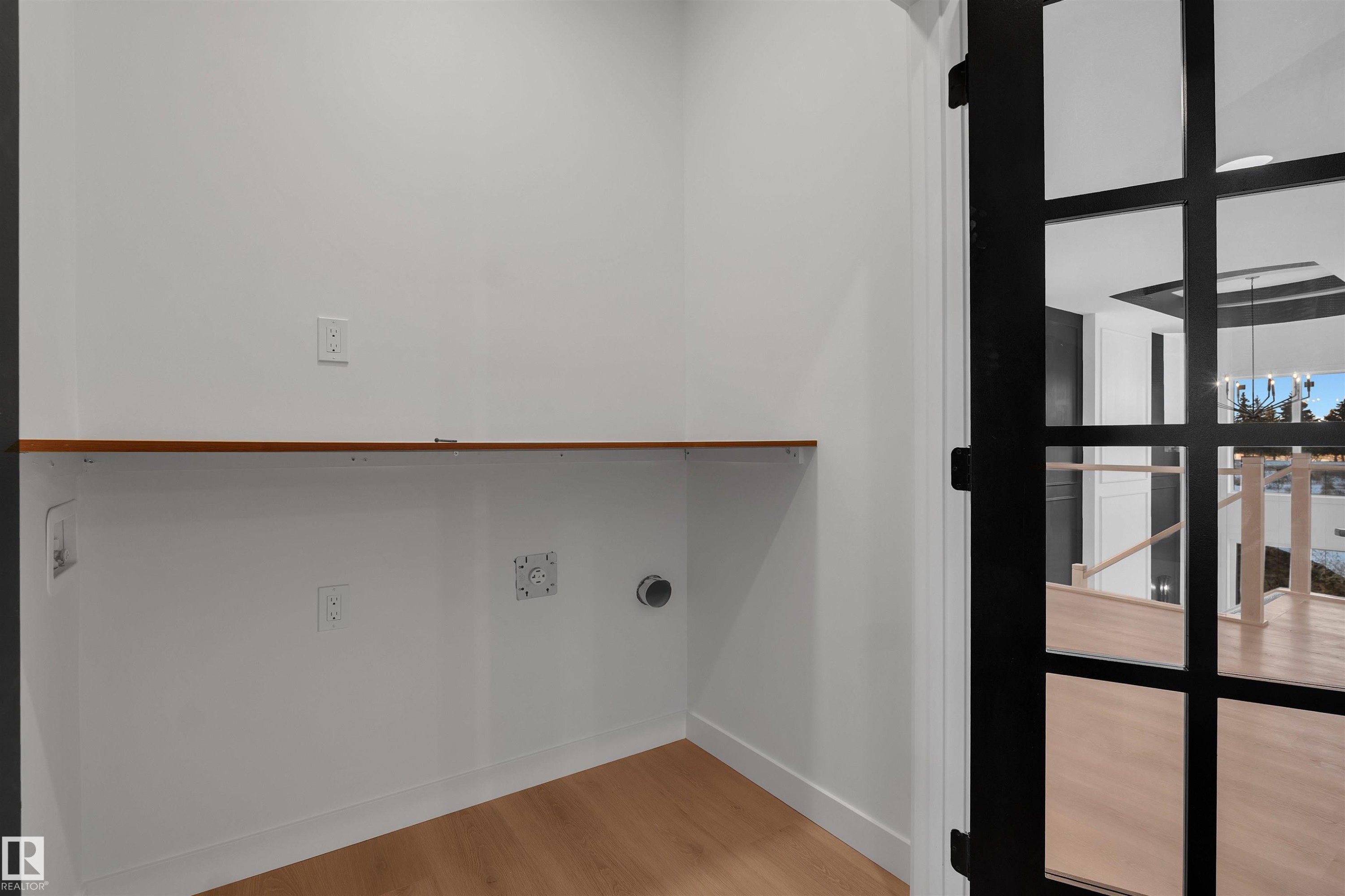 Laundry area featuring light wood-style flooring and baseboards - 34 Grayson Green, Stony Plain, AB - Indoor Photo Showing Other Room